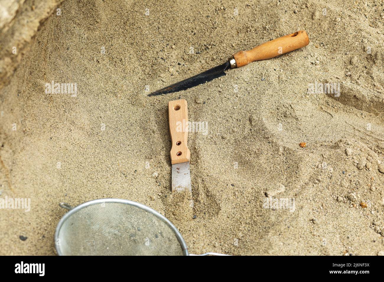 Shovel in the sand.Skeleton and archaeological tools.Digging for