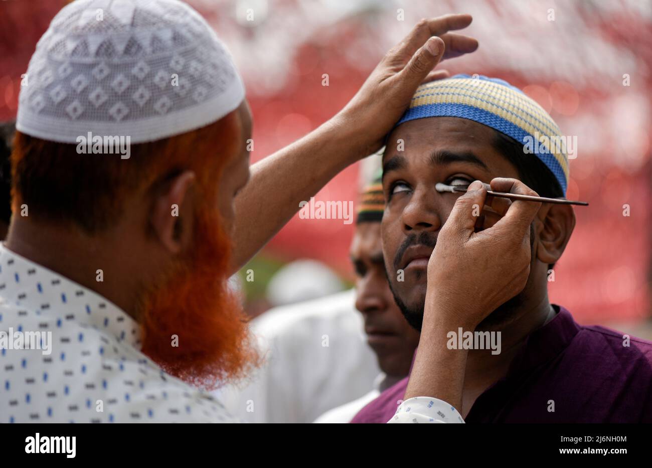 Guwahati, Assam, India. 03rd May, 2022. A Muslim man applying Surma on eyes before offer prayer at a Eidgah to start the Eid al-Fitr festival, which marks the end of their holy fasting month of Ramadan, in Guwahati, Assam, India on May 03, 2022. Credit: David Talukdar/Alamy Live News Stock Photo