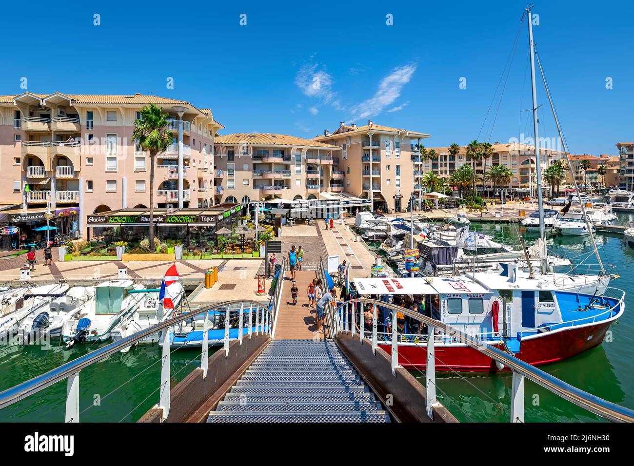 View of boats and yachts as houses and promenade with restaurants on background in Frejus - city on French Riviera. Stock Photo