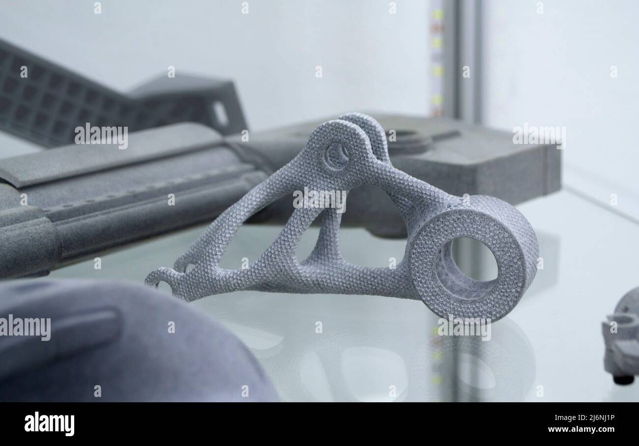 Many different models printed on 3D printer. Gray objects printed on 3D printer Stock Photo