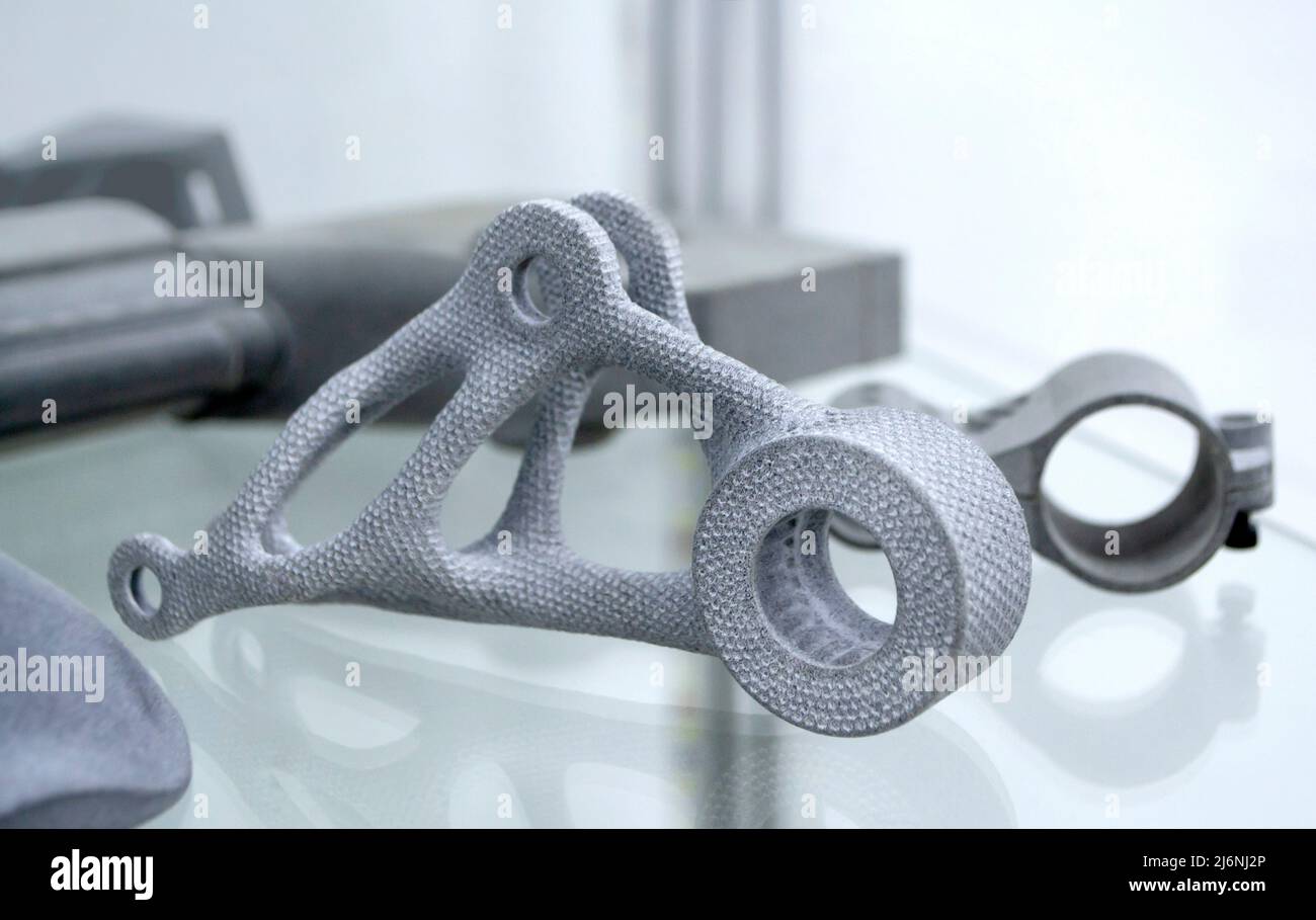 Many different models printed on 3D printer. Gray objects printed on 3D printer Stock Photo
