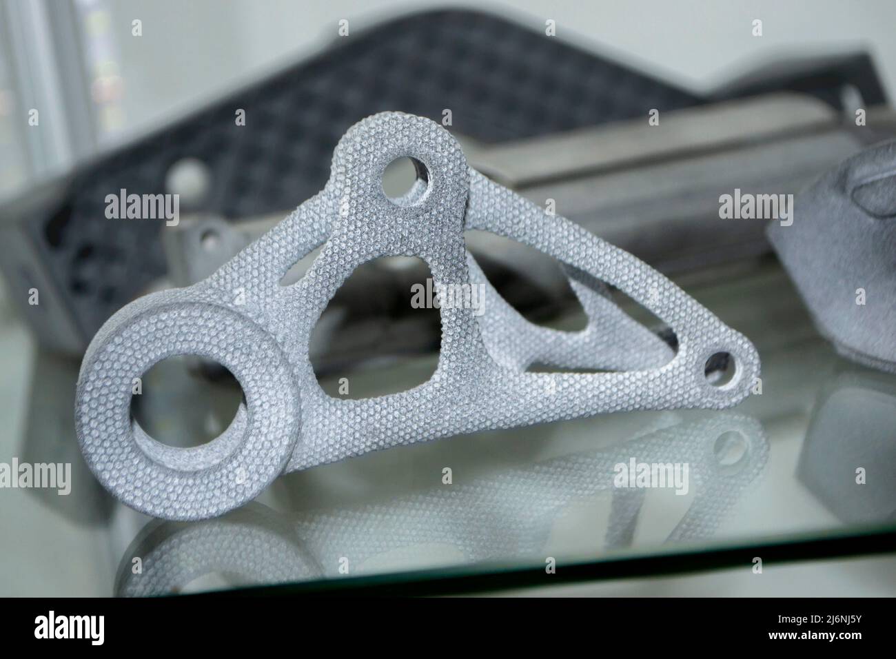 Many different models printed on 3D printer. Gray objects printed on 3D printer Stock Photo