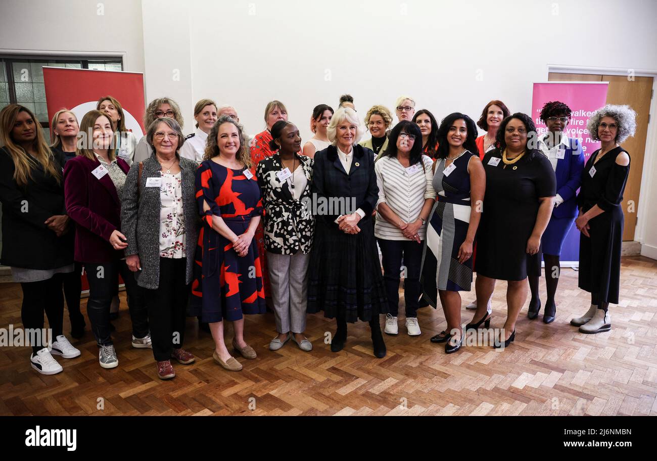 The Duchess of Cornwall poses for a photo with the photographer, survivors and guests at a reception while attending the I Am photography exhibition, a new collection of portraits of survivors of domestic abuse by award-winning photographer Allie Crew, at Manchester Central Library during a visit to Greater Manchester. Picture date: Tuesday May 3, 2022. Stock Photo