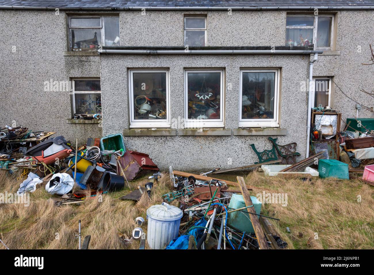 House with junk and rubbish in the garden, UK Stock Photo