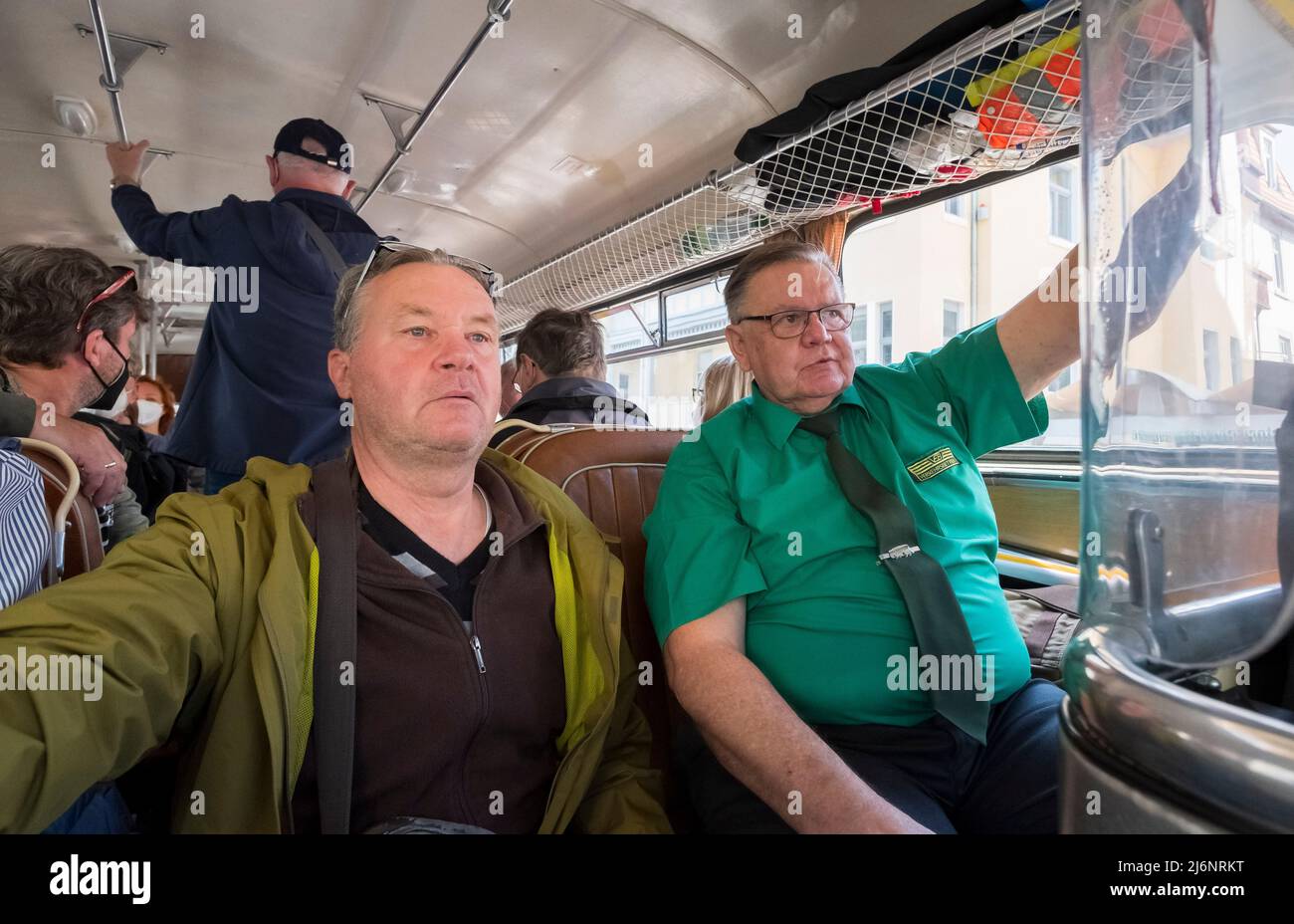 03 May 2022, Saxony, Dresden: Passengers and transport company employees ride in an 'Ikarus 66'. The bus was built in the Hungarian Ikarus factories in 1972, has 190 hp and was in regular service in Dresden until 1985. A total of 3 historic buses of the Historisches Kraftfahrzeuge des Dresdner Nahverkehrs e. V. are on the road in Dresden this week on the occasion of the 20th anniversary of the association. Photo: Matthias Rietschel/dpa-Zentralbild/dpa Stock Photo