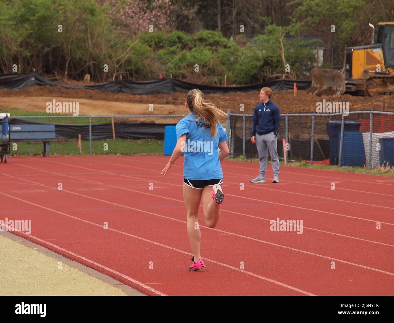 Young girl competing in a middle school track meet hires stock