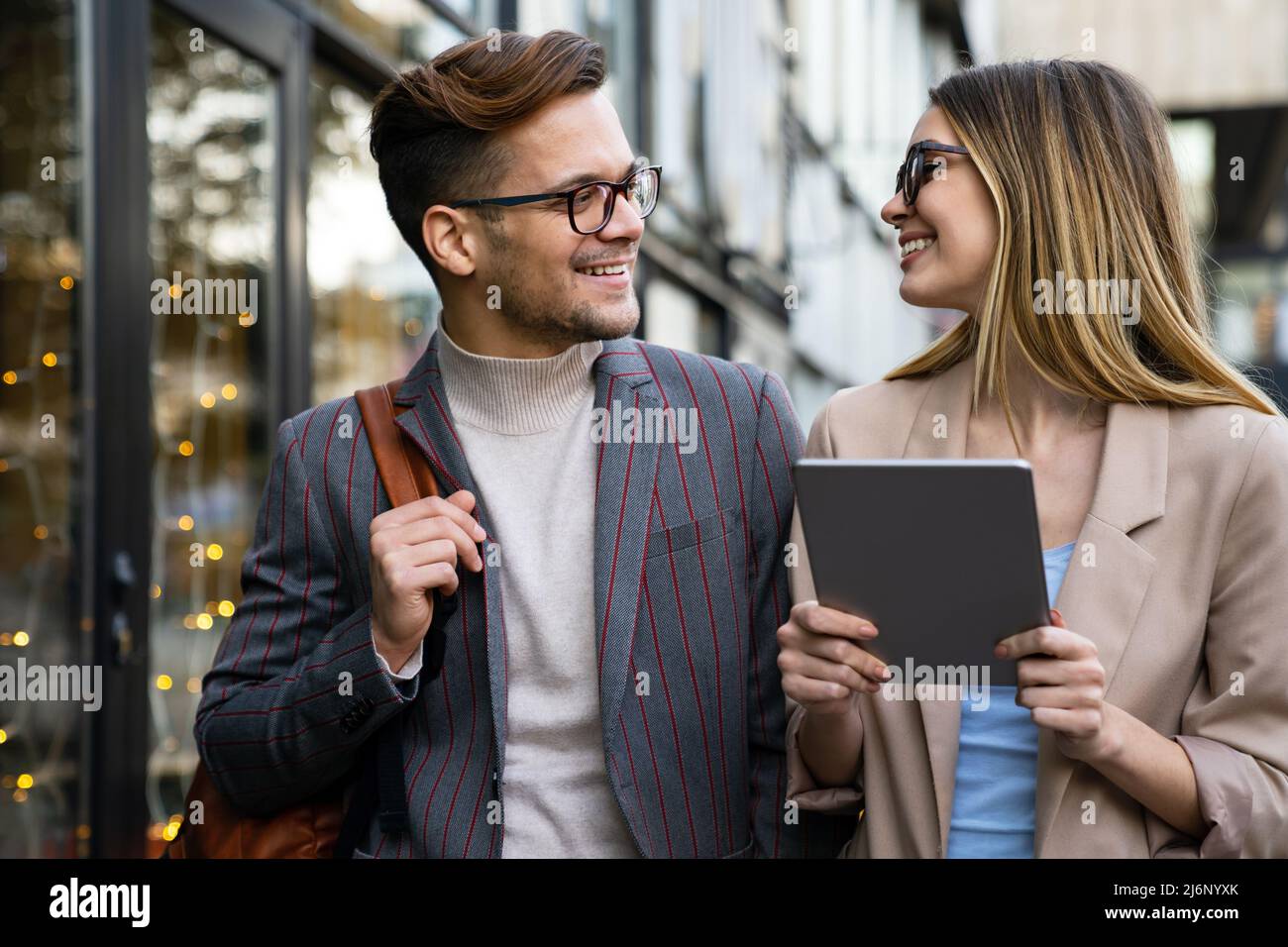 Portrait of successful business people working, talking together in urban background. Stock Photo