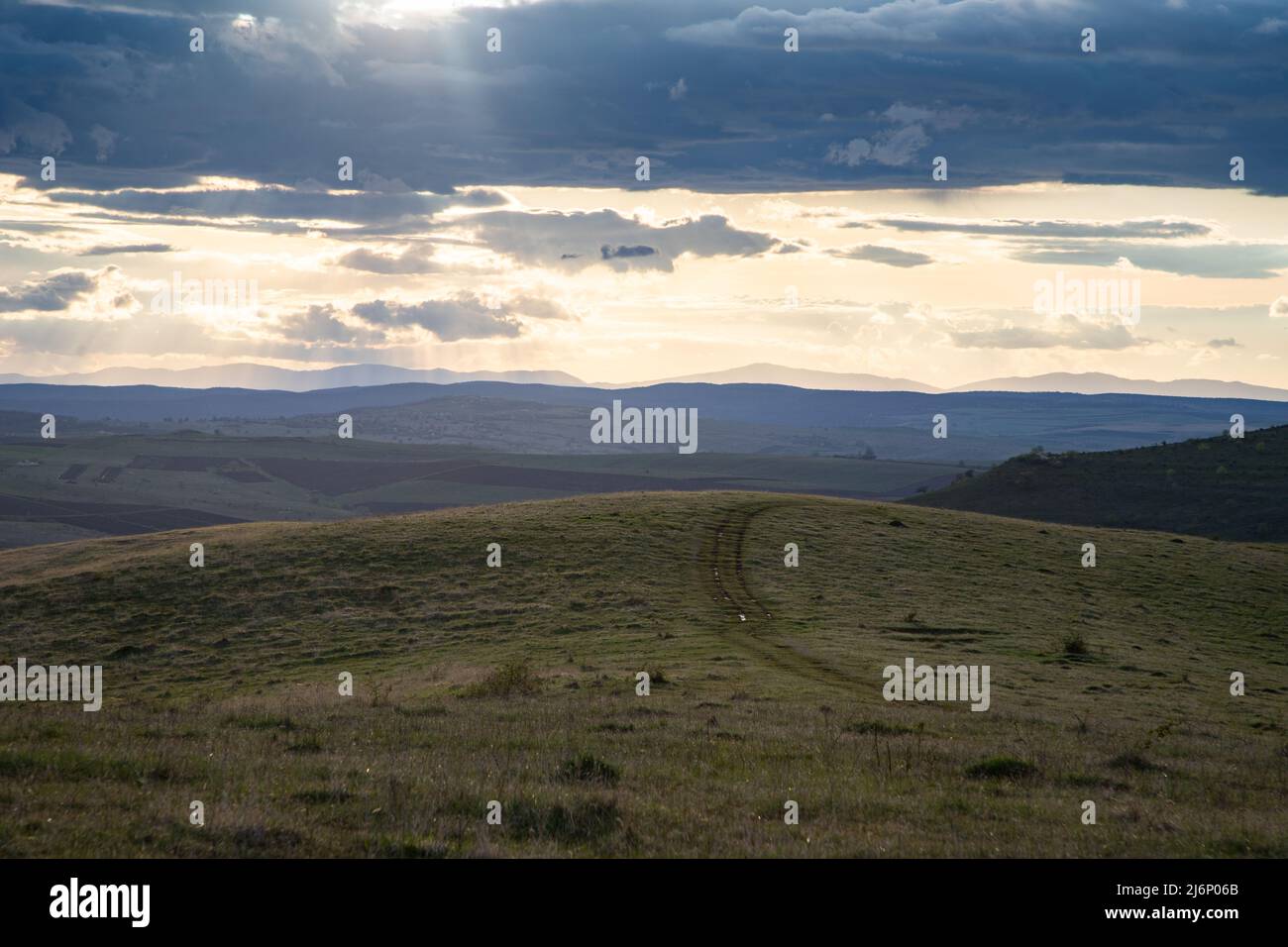 amazing sunset sky over green hills in early summer Stock Photo - Alamy