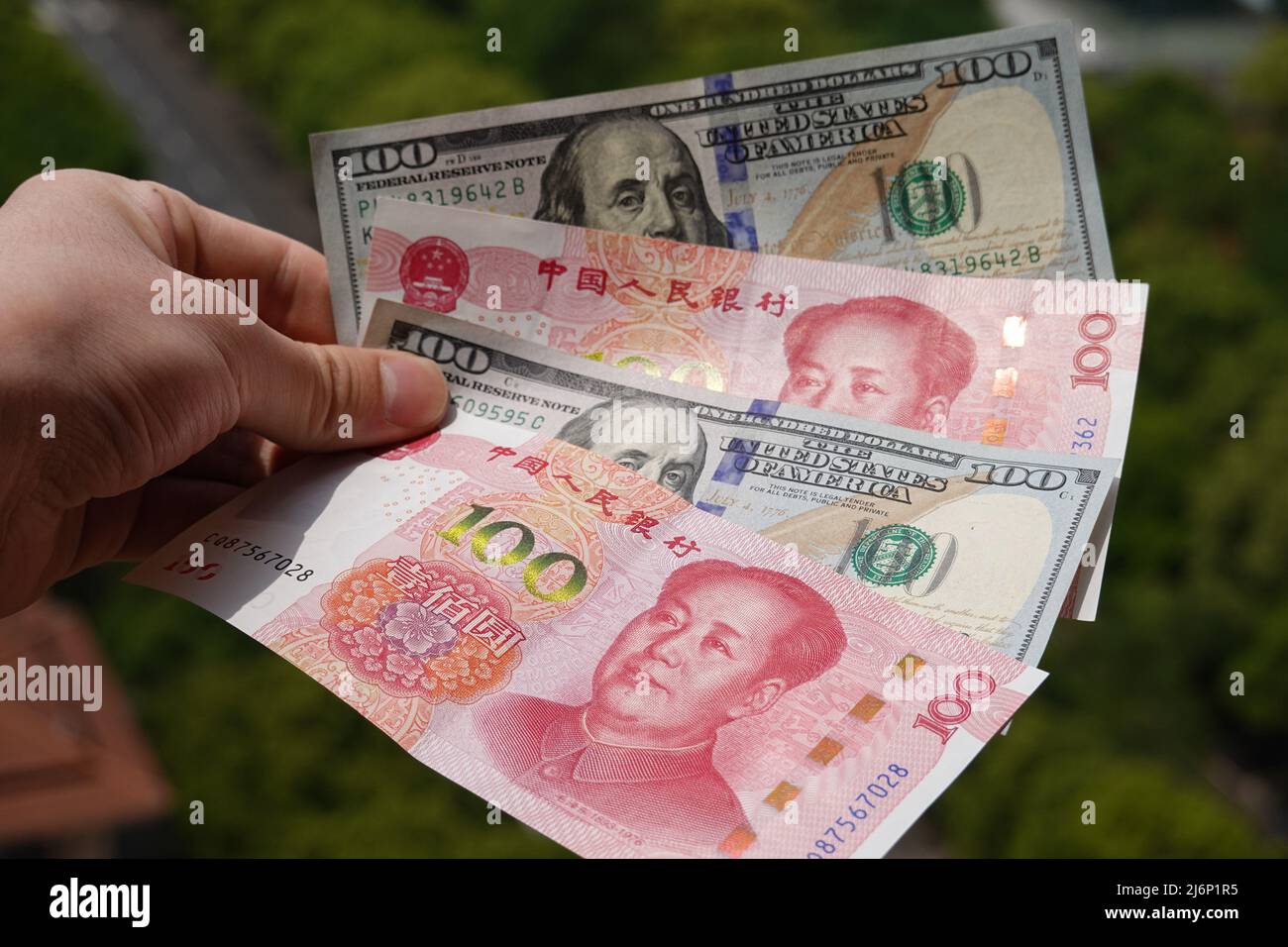 In this photo illustration, 100 US dollar notes and 100 RMB notes seen ...