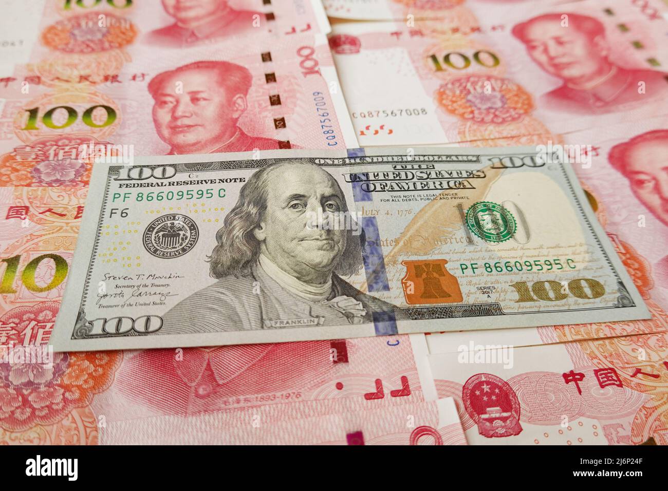 In this photo illustration, 100 US dollar notes and 100 RMB notes seen ...