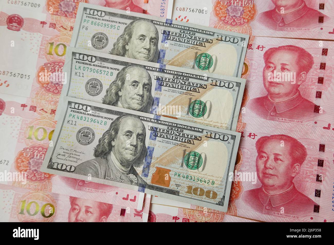 In this photo illustration, 100 US dollar notes and 100 RMB notes seen ...