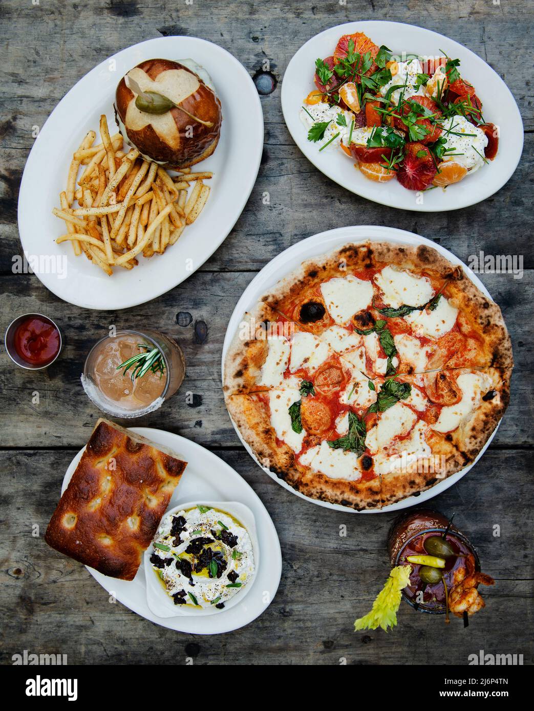 Italian food spread with Margherita pizza, salad, burger Focaccia and