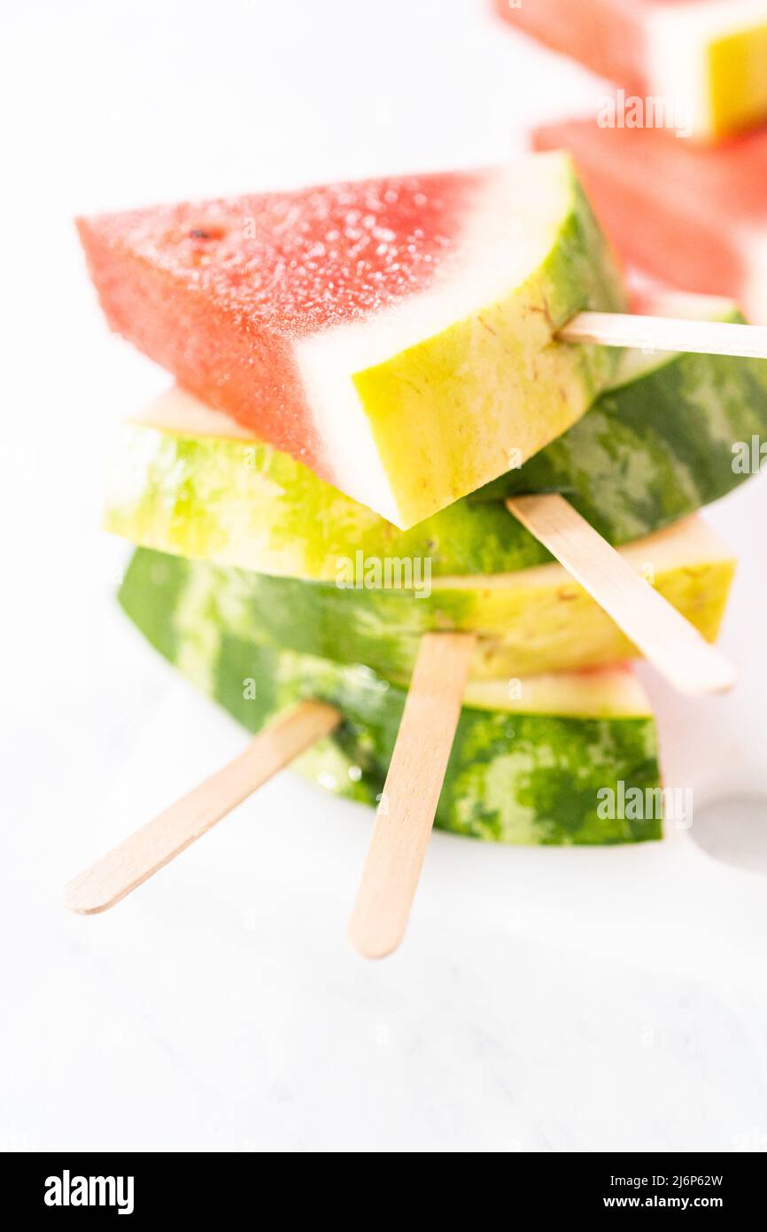 Slicing riped red watermelon to prepare chili lime watermelon pops ...