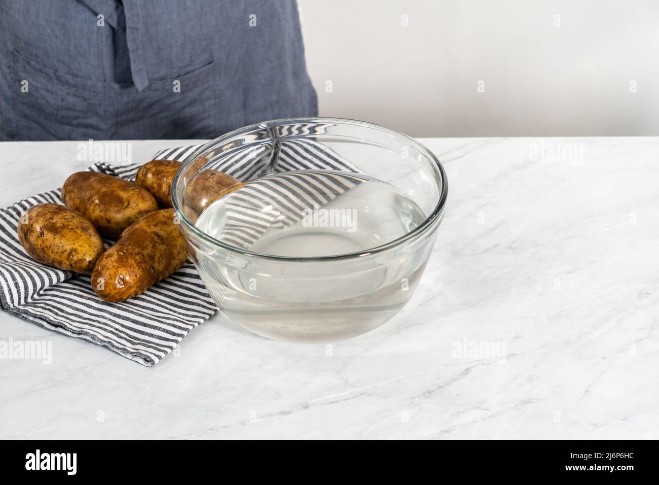 Pressure Cooker Baked Potatoes. Washing raw potatoes in a glass mixing