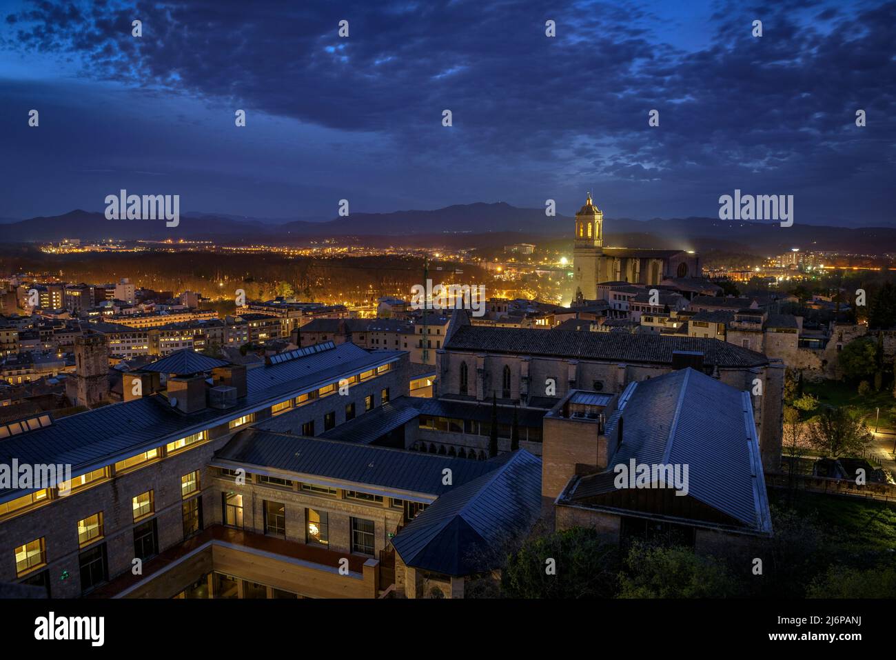 The city of Girona seen from the Sant Domènec tower in the wall of Girona, at twilight and night (Girona, Catalonia, Spain) ESP: Ciudad de Gerona Stock Photo
