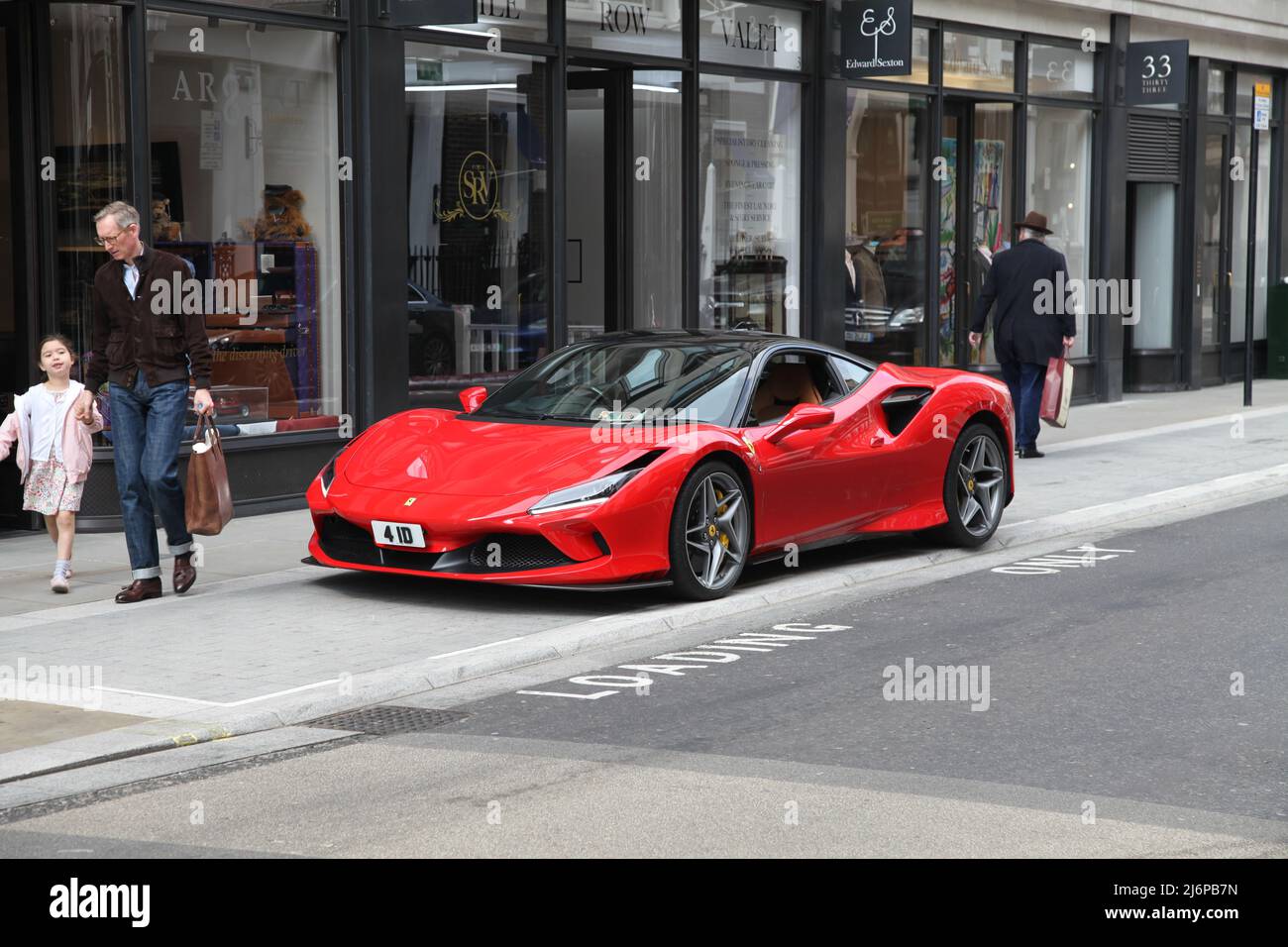 Red Ferrari F8 Tributo sports car parked on Savile Row, West End, London, England, UK, 2022 daytime Stock Photo