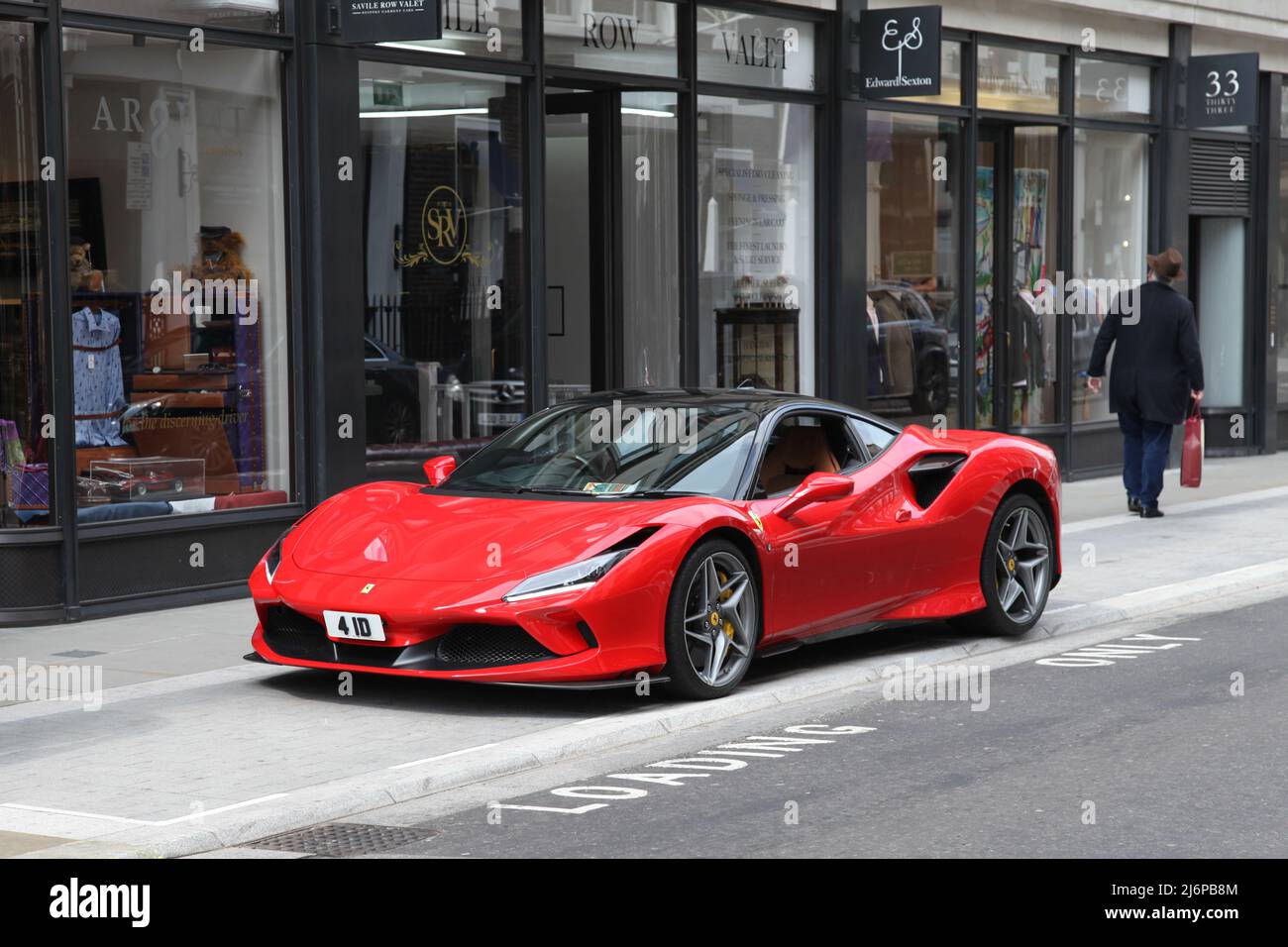 Red Ferrari F8 Tributo sports car parked on Savile Row, West End, London, England, UK, 2022 daytime Stock Photo