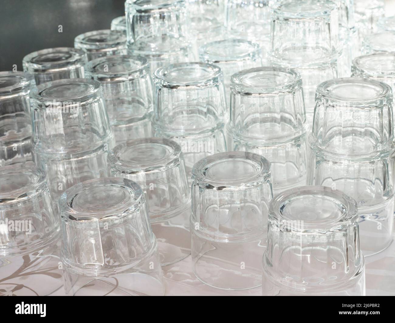 Tower of empty vodka glasses on a buffet Stock Photo