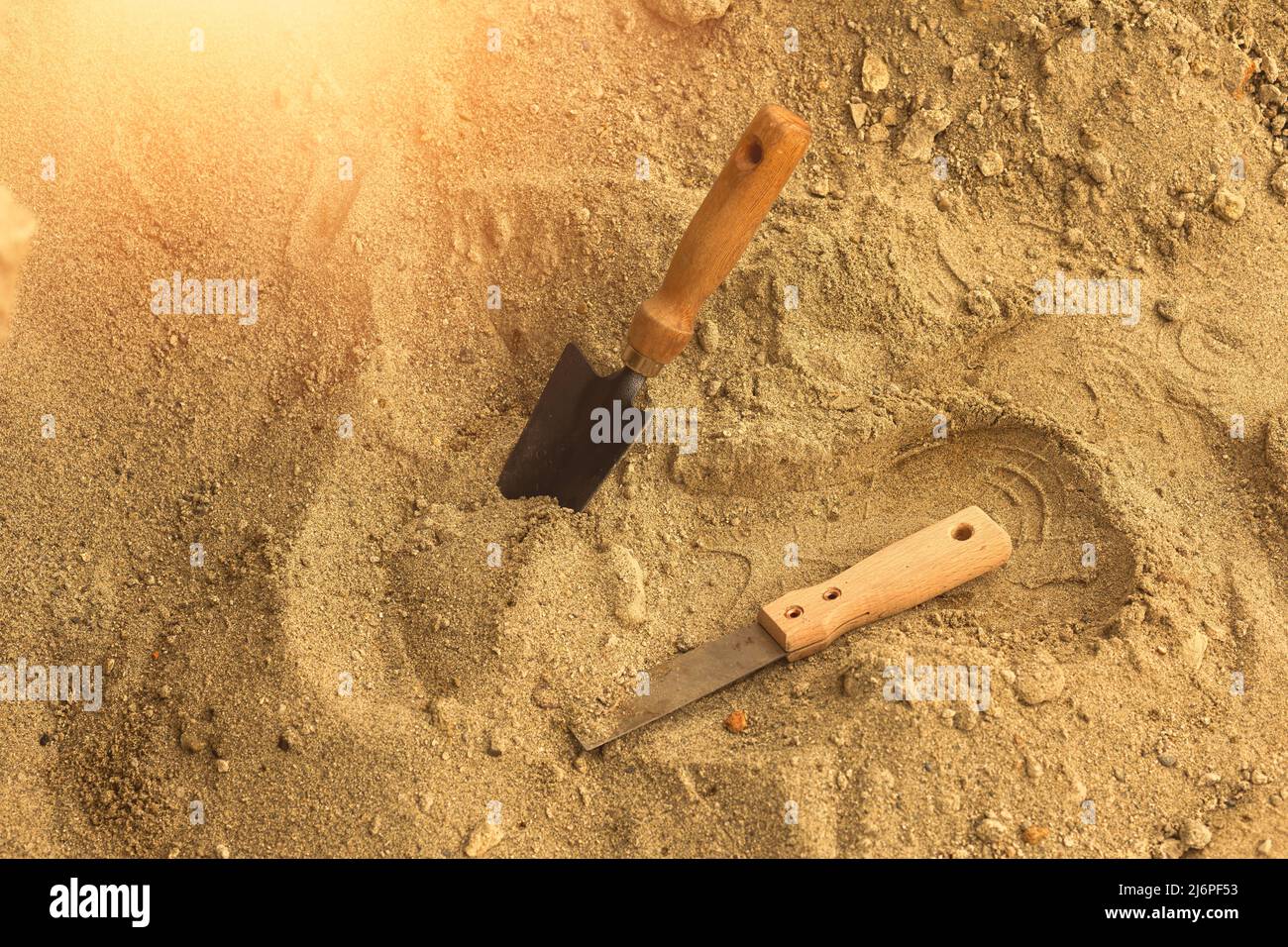 Shovel in the sand.Skeleton and archaeological tools.Digging for