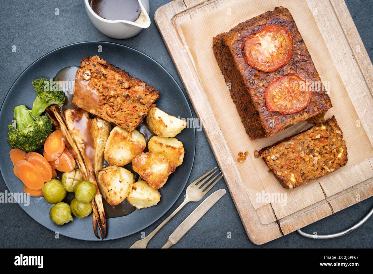 Vegan nut roast / nut loaf on a wooden board with a nut roast dinner