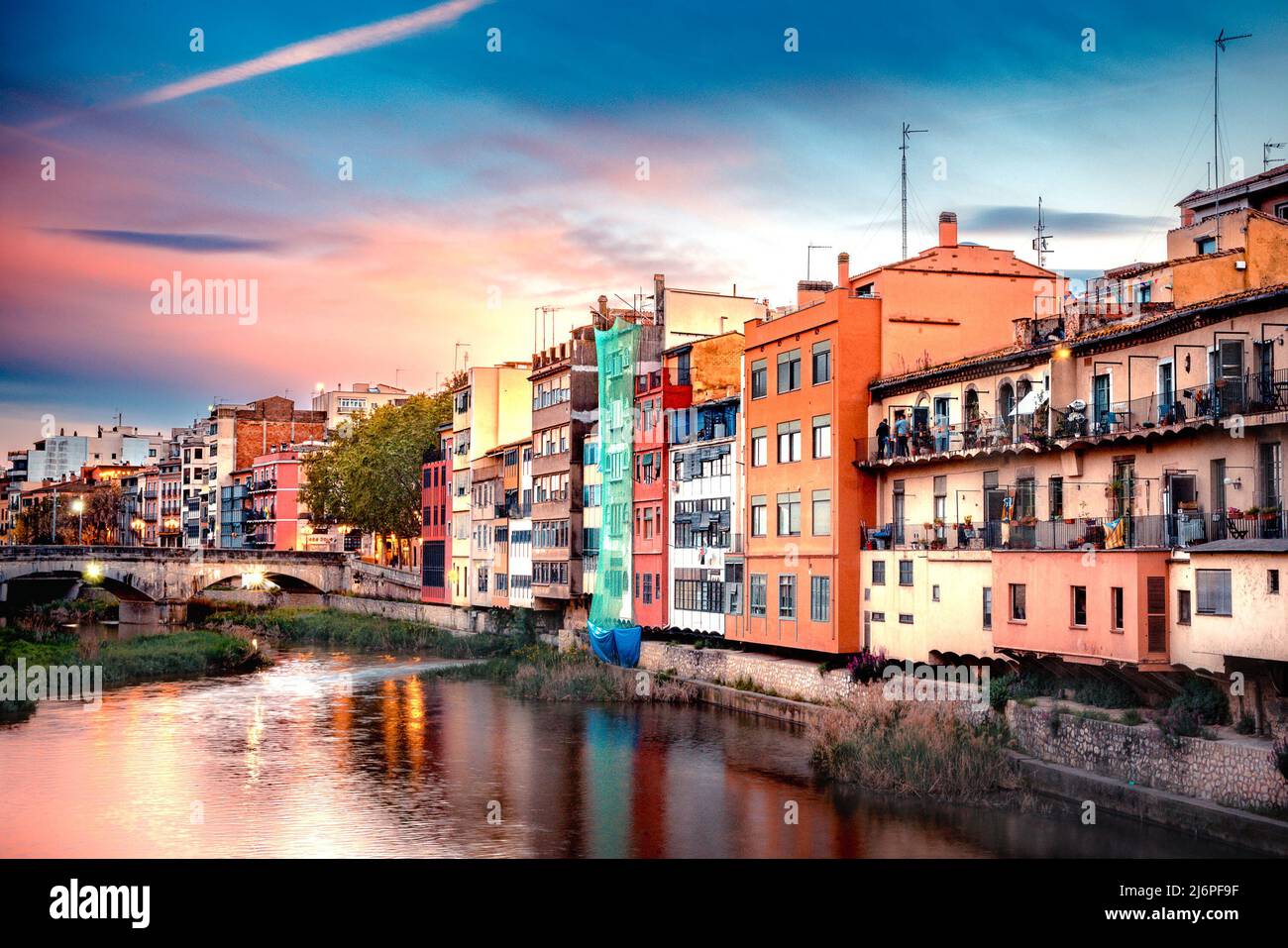 Girona Spain with canal and historic colorful buildings seen at sunset. Stock Photo