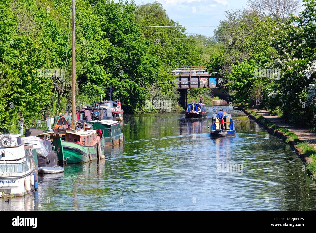 Two narrow boats cruising on the Paddington branch of the Grand Union ...