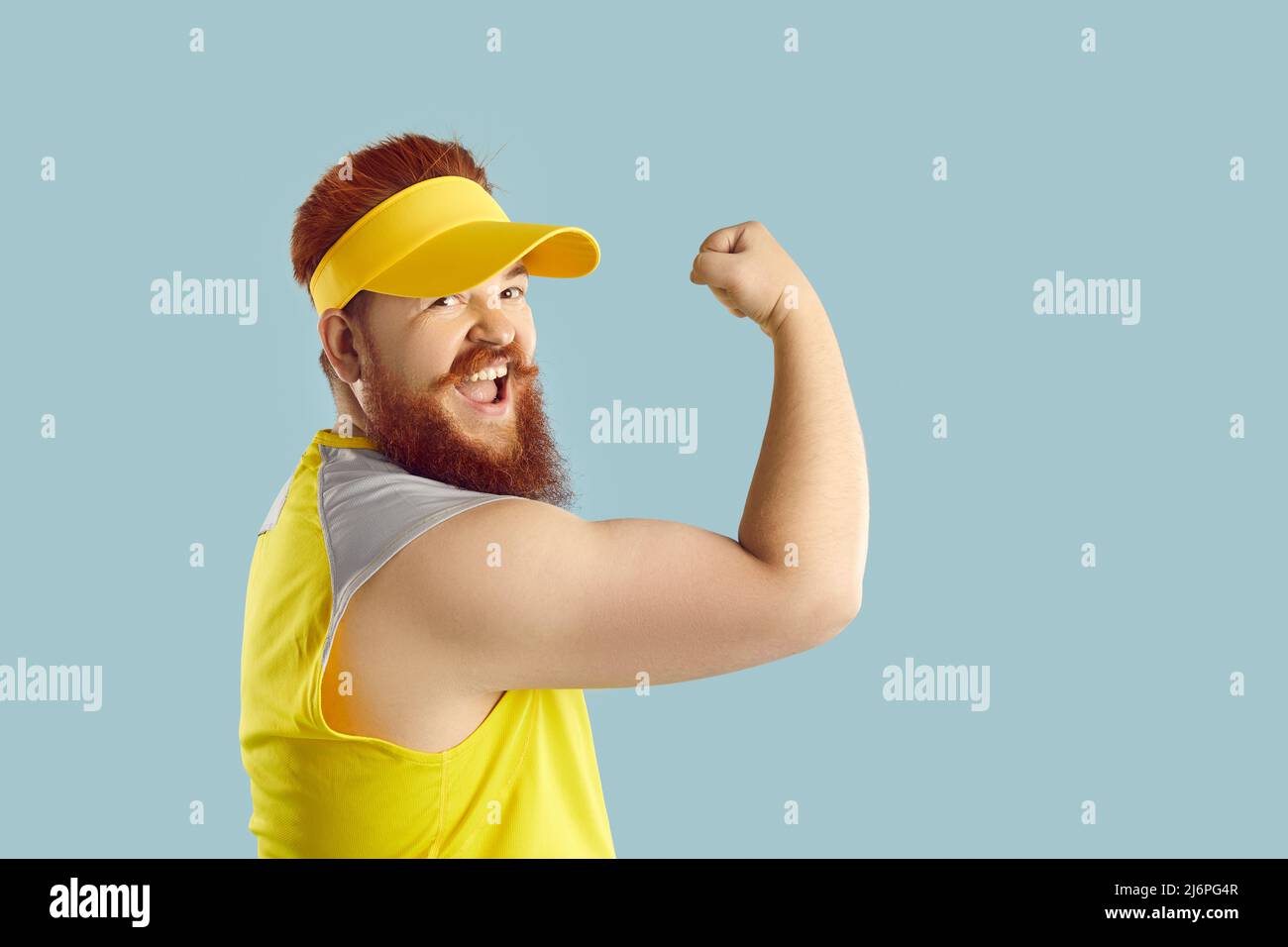 Funny happy strong fat man doing fitness exercises during his workout at the gym Stock Photo