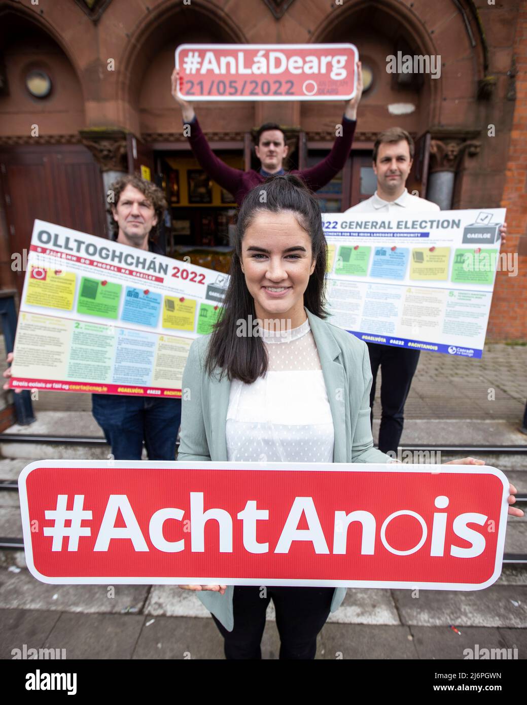 (From left) Julian de Spainn, Chisel Nic Liam, Padraig O Tiarnaigh, and Conchur O Muadaigh, from Conradh na Gaeilge, standing with placards at Culturlann McAdam O Fiaich in Belfast calling for local parties to sign up to key Irish language commitments for the Irish language community in the run up to Thursday's 2022 Northern Ireland Assembly Election. Stock Photo