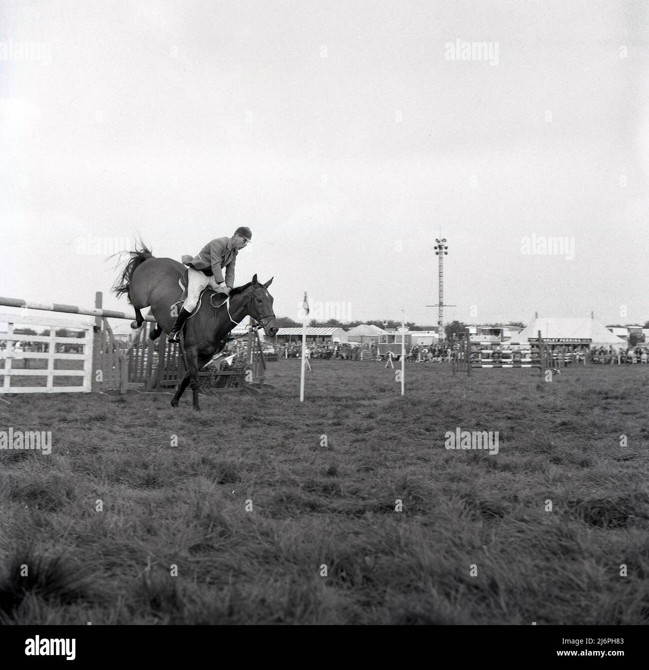 1967, historical, male show jumper, Peter Robeson having just jumped a fence or obstacle on the equestrian course at the Bucks County Show, Buckinghamshire, England, UK. Robeson was a two-time British Olympic bronze medal winner, in the 1956 and 1964 summer Olympics games. Stock Photo