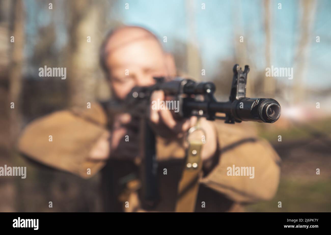 muzzle of a machine gun close-up in the hands of a man Stock Photo