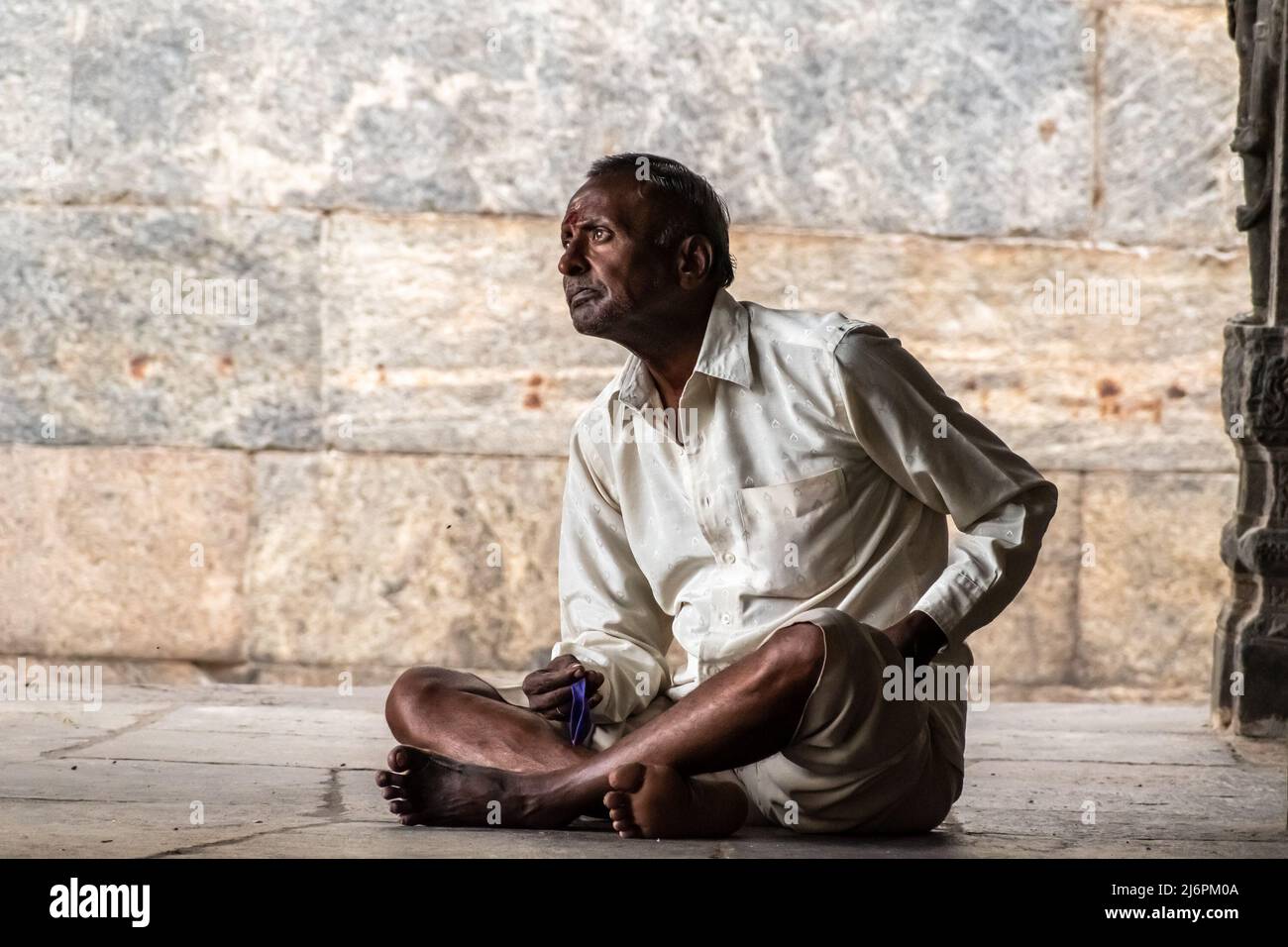 man sitting cross legged side view