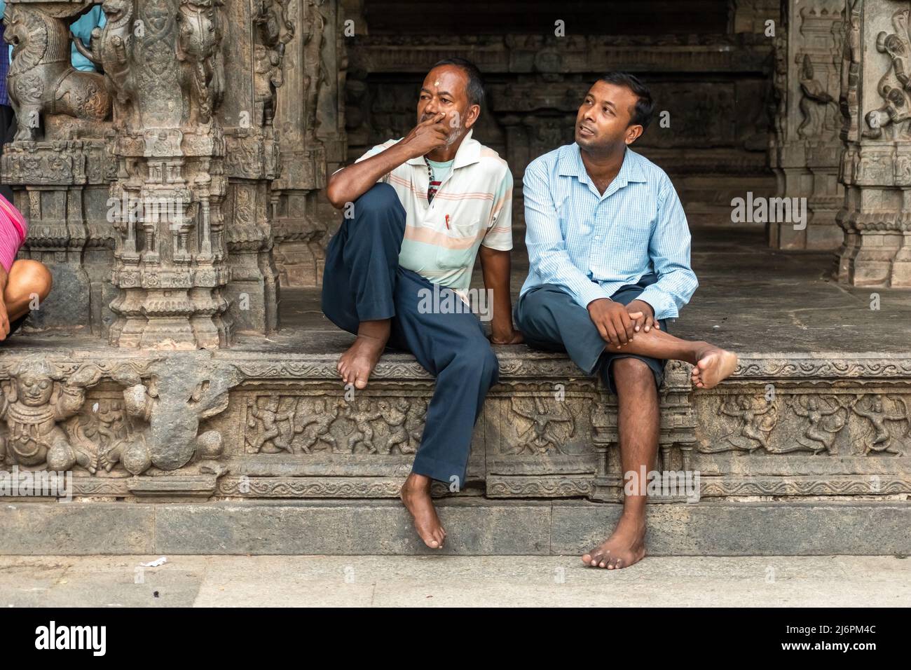 Vellore, Tamil Nadu, India - September 2018: Two Indian men sitting in the ancient Hindu temple at the Vellore Fort. Stock Photo