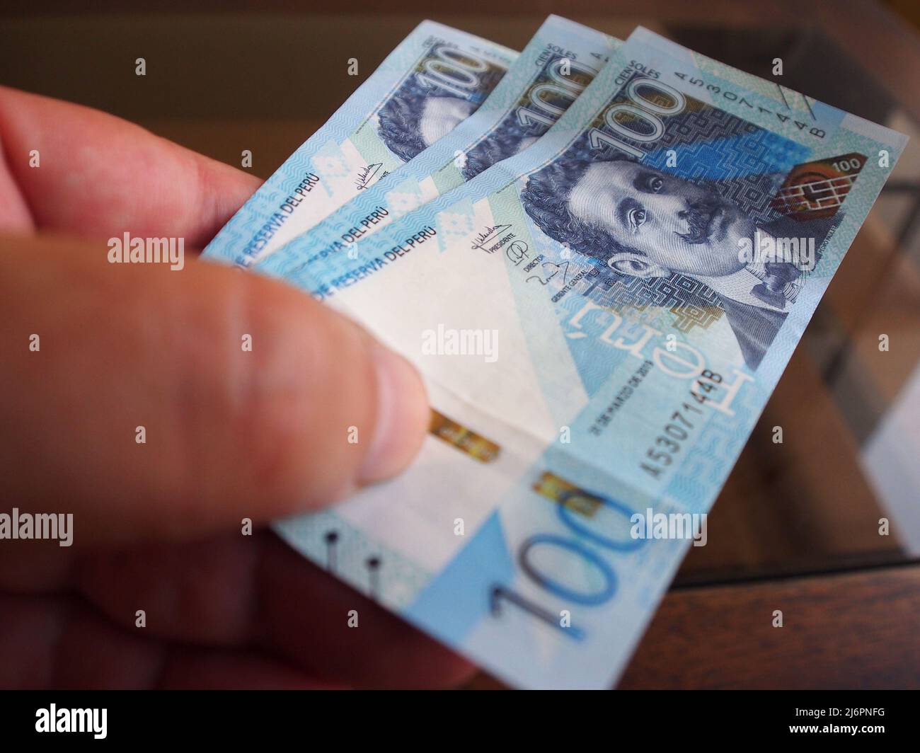 In this photo illustration, Peruvian Sol banknotes being handled. The