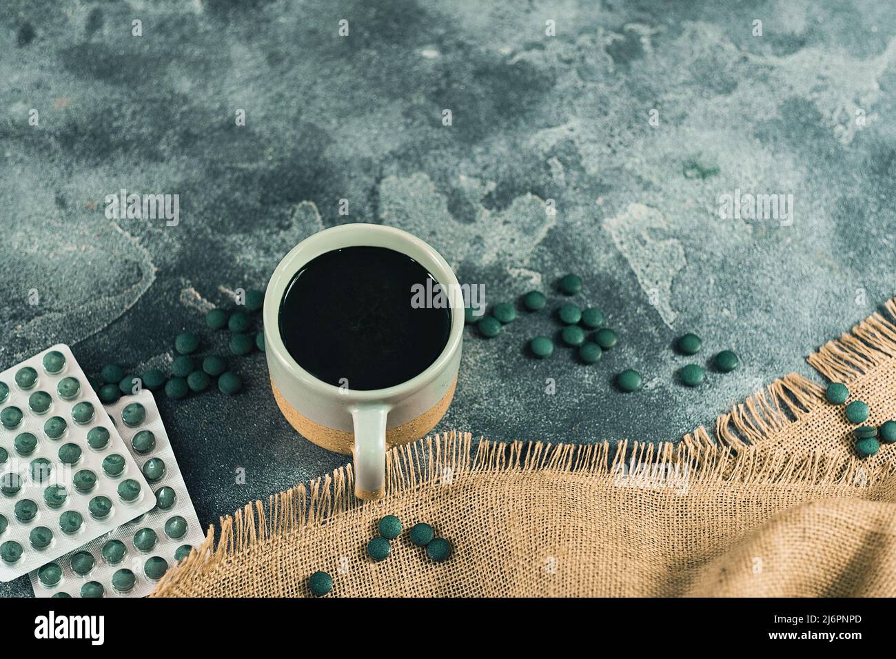 Spirulina pills tablets pack and a mug with a drink Stock Photo Alamy