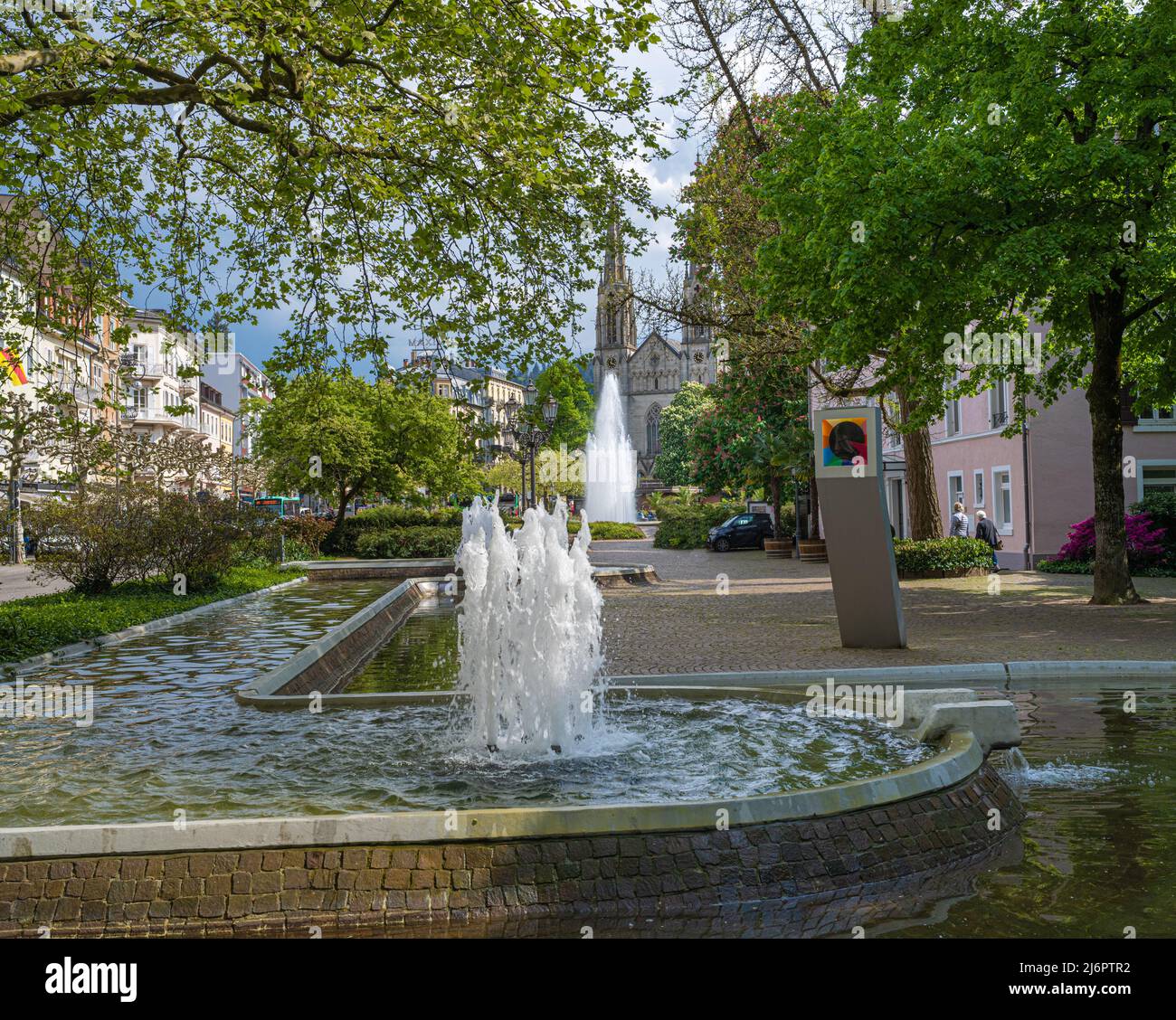 Water fountains in Baden Baden with the town church in the background. Baden Wuerttemberg, Germany, Europe Stock Photo