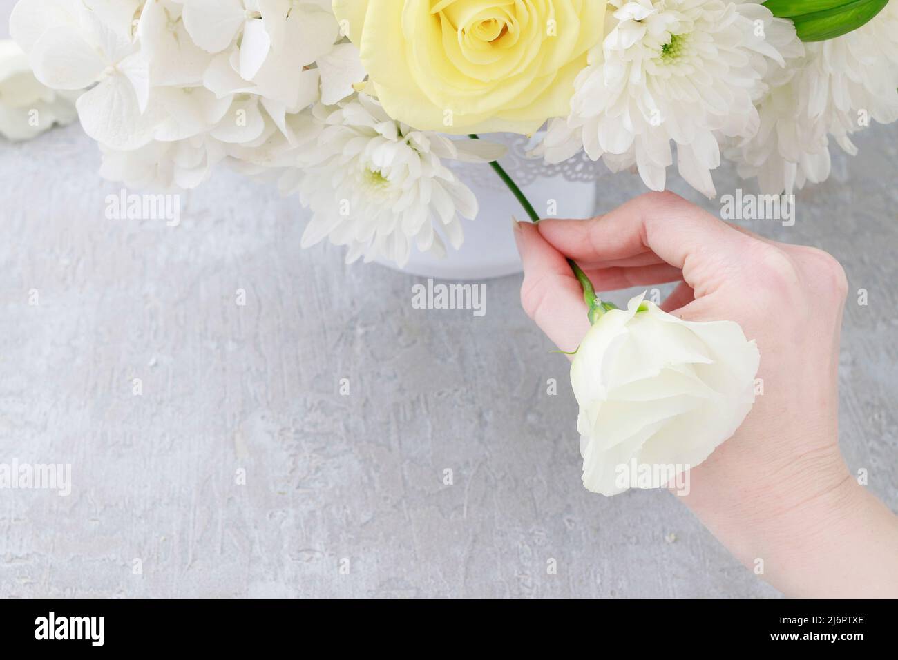 Florist at work how to make luxurious floral arrangement with lilies, roses, eustoma