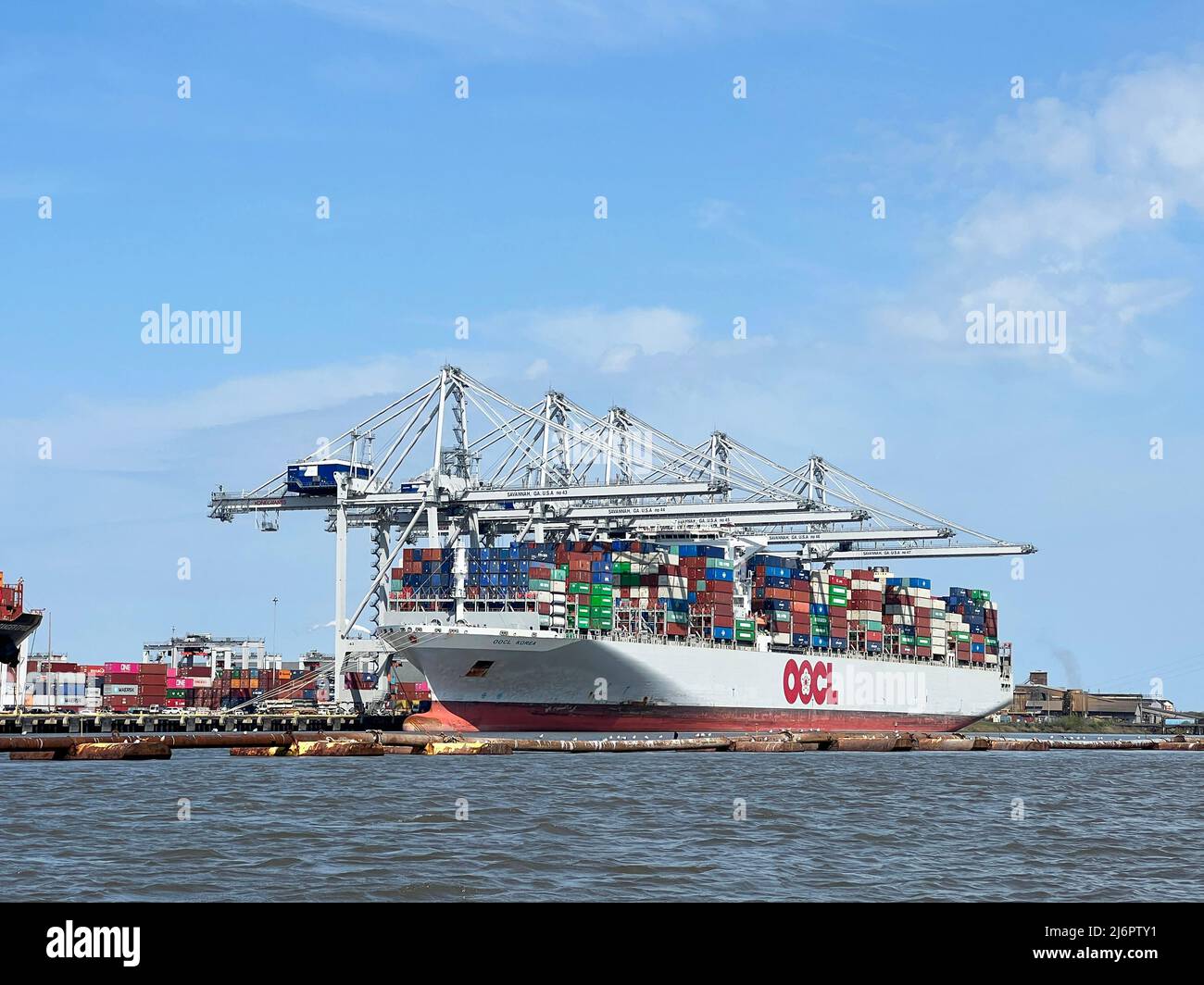 Savannah, Georgia, USA - March 29, 2022: Shipping containers loading and unloading in port are a part in the global supply chain. Stock Photo
