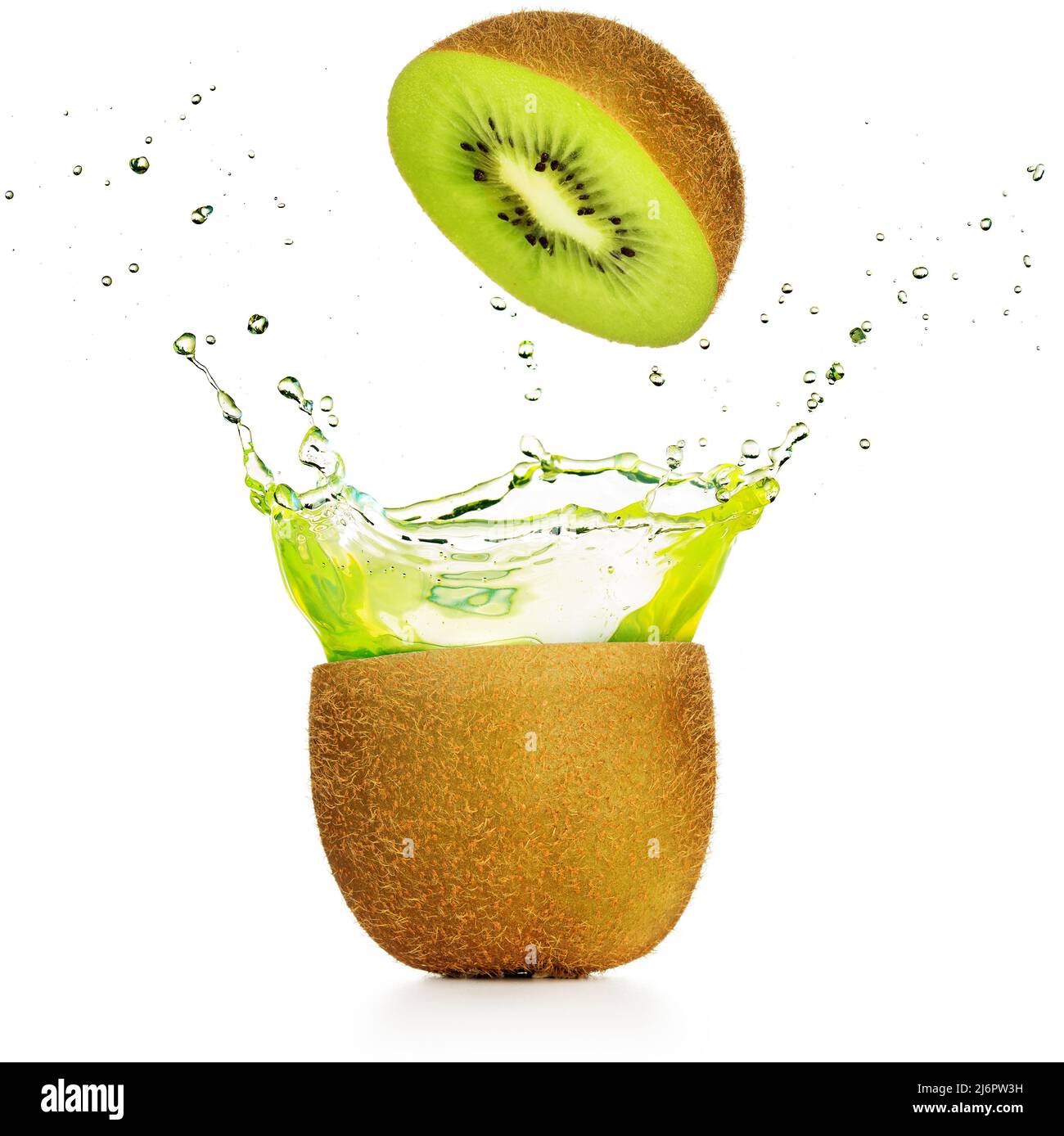 green juice exploding out of a kiwi isolated on white Stock Photo