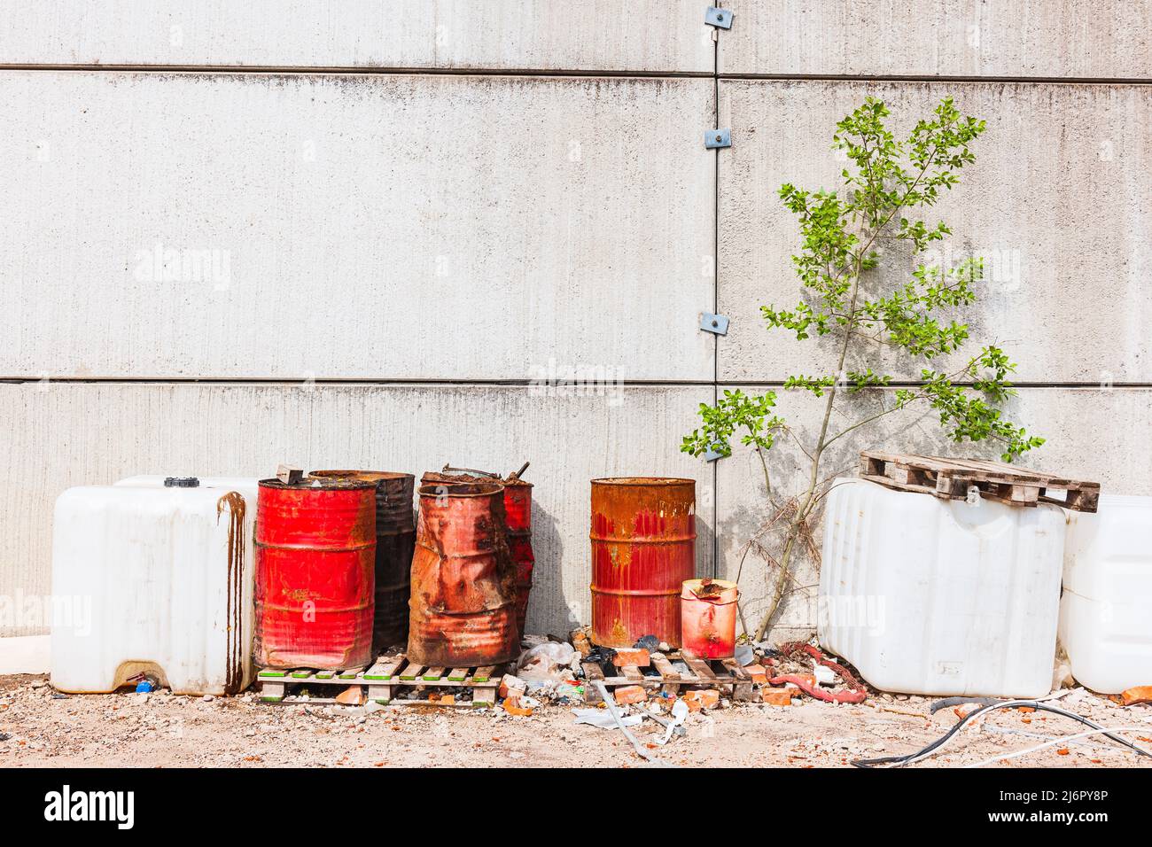 Rusty old barrels outside industry facade Stock Photo