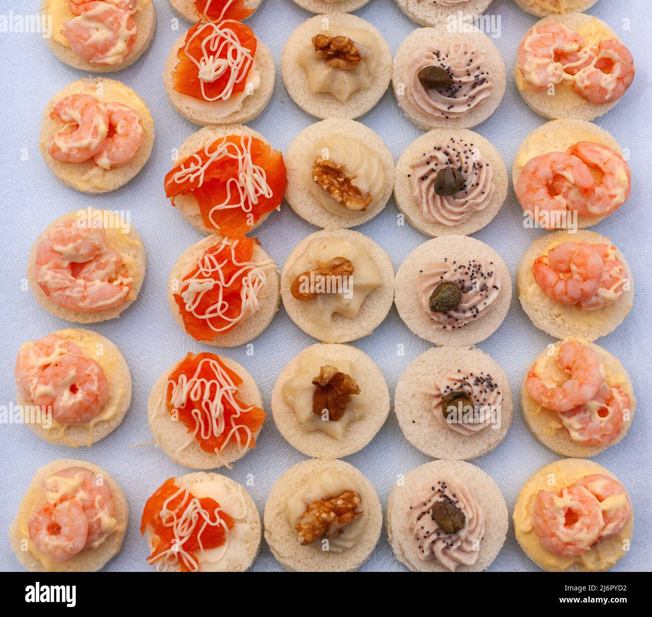 Flat lay of delicious seafood canapes, made with Salmon, shrimps, tuna sauce and creamed cod Stock Photo