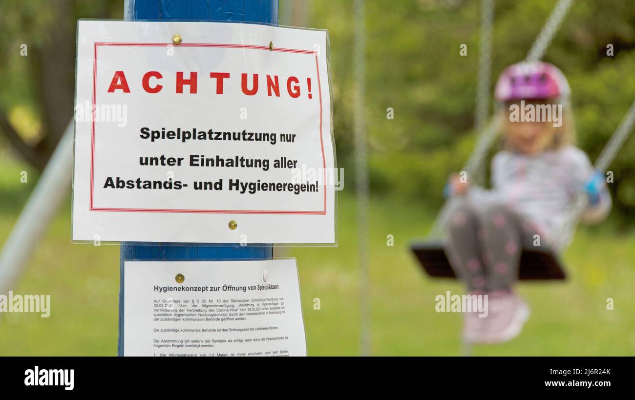 Playground with information (in German) about playground use due to coronavirus Stock Photo