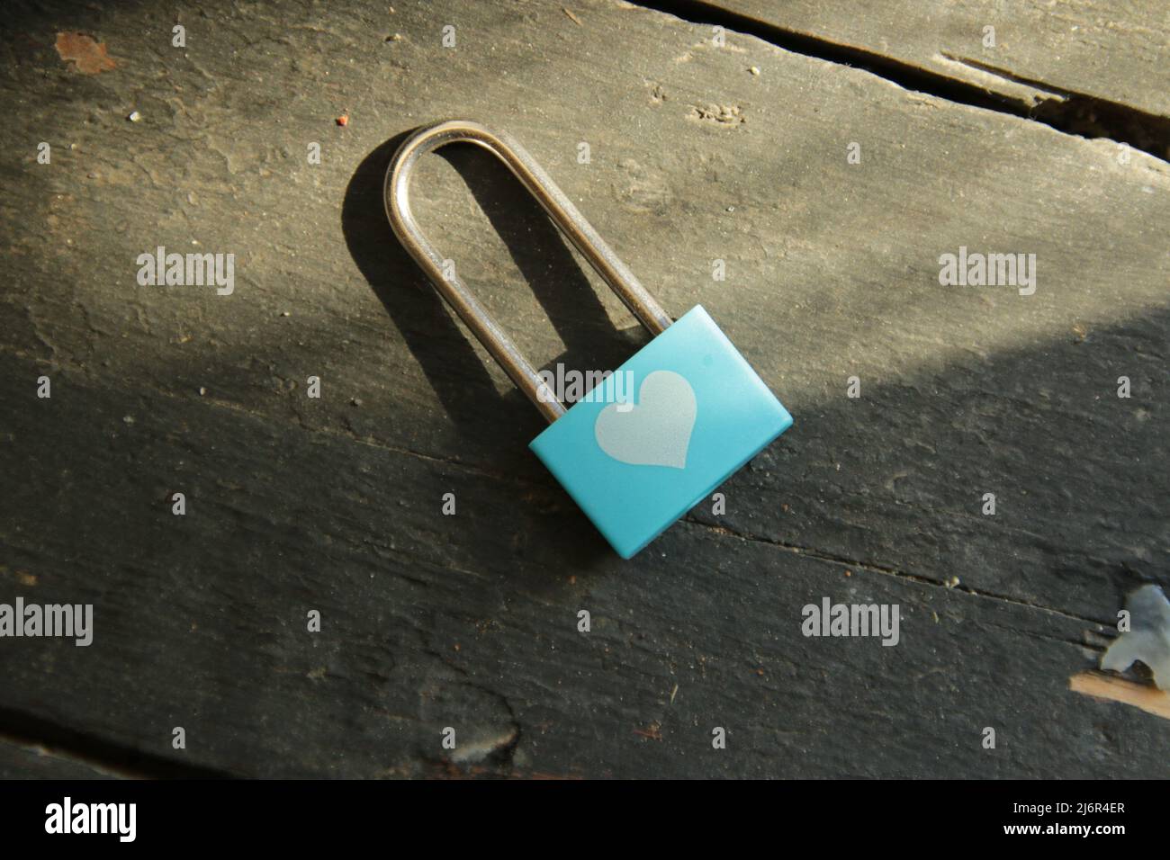 Valentine card. Blue padlock with white heart pattern. Stock Photo