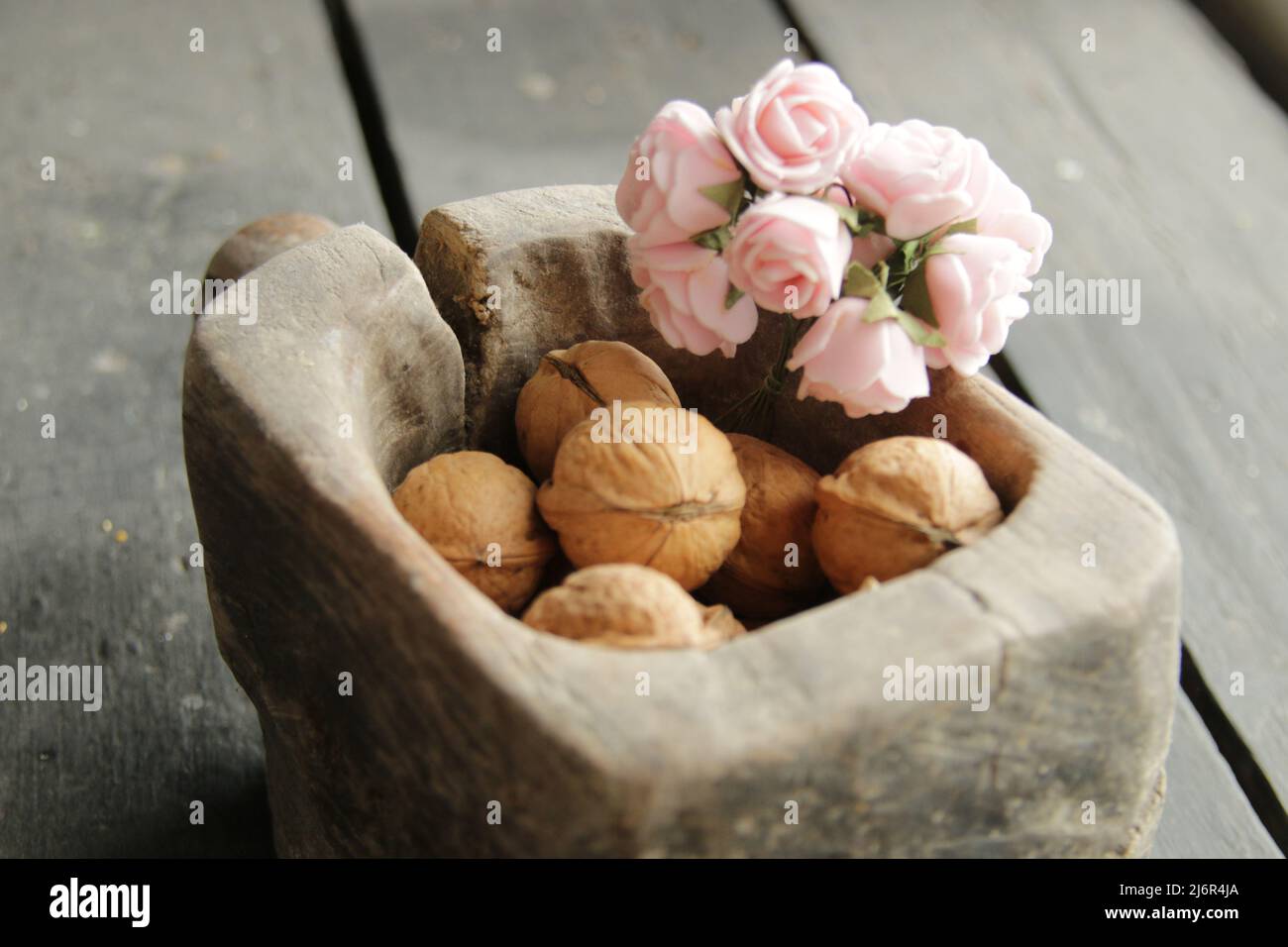 Healthy food. Beautiful flowers and walnuts in a wooden box. Stock Photo