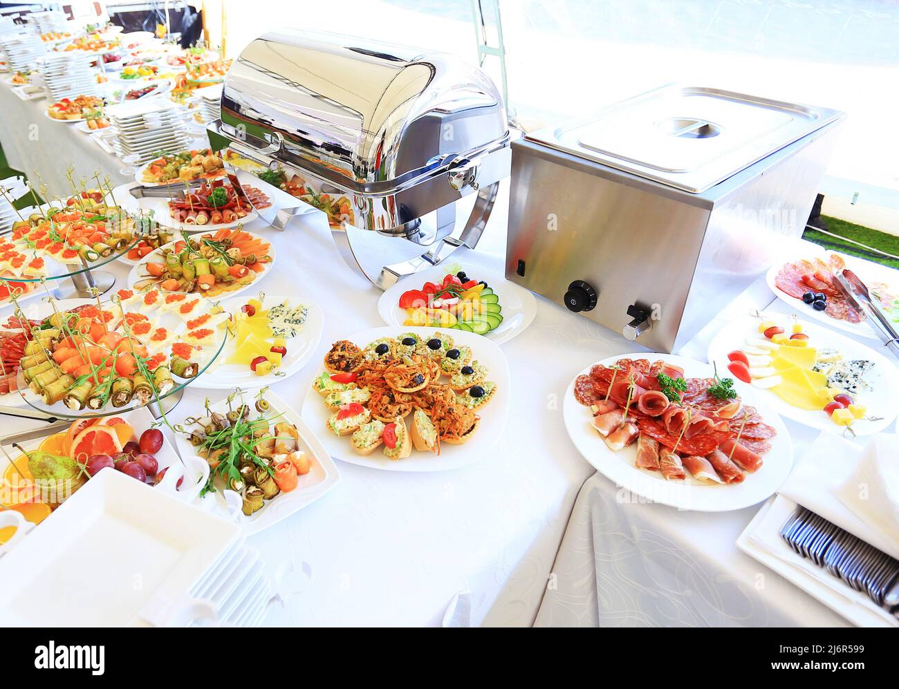 catering table set service with silverware and glass stemware at