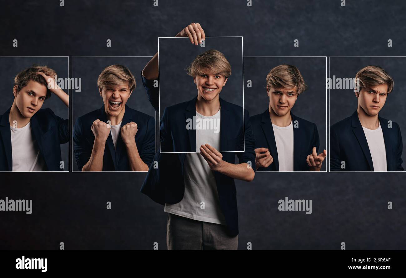 young man holding face portraits with different emotions Stock Photo