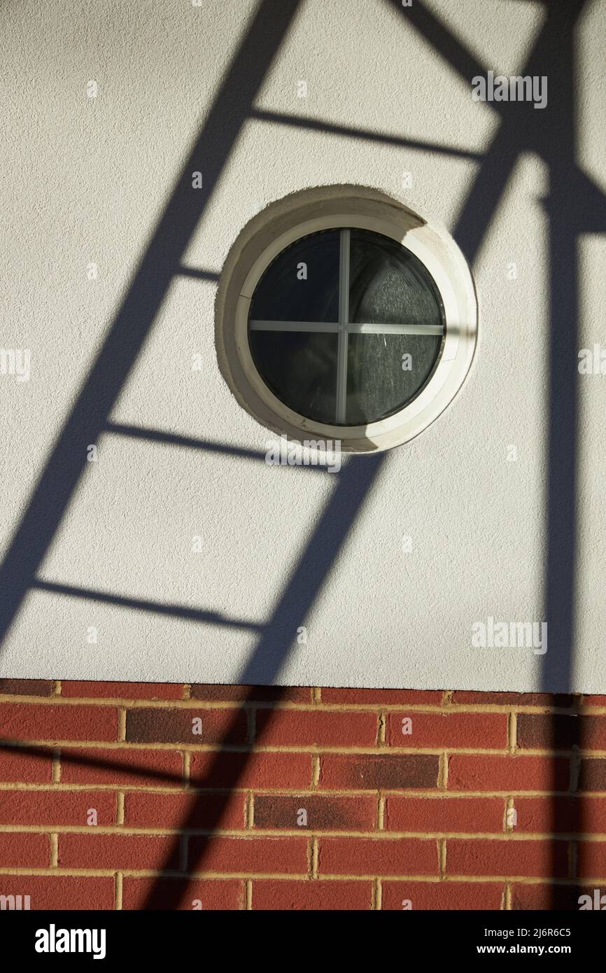 Shadows on At Deco building with bulls-eye window Stock Photo