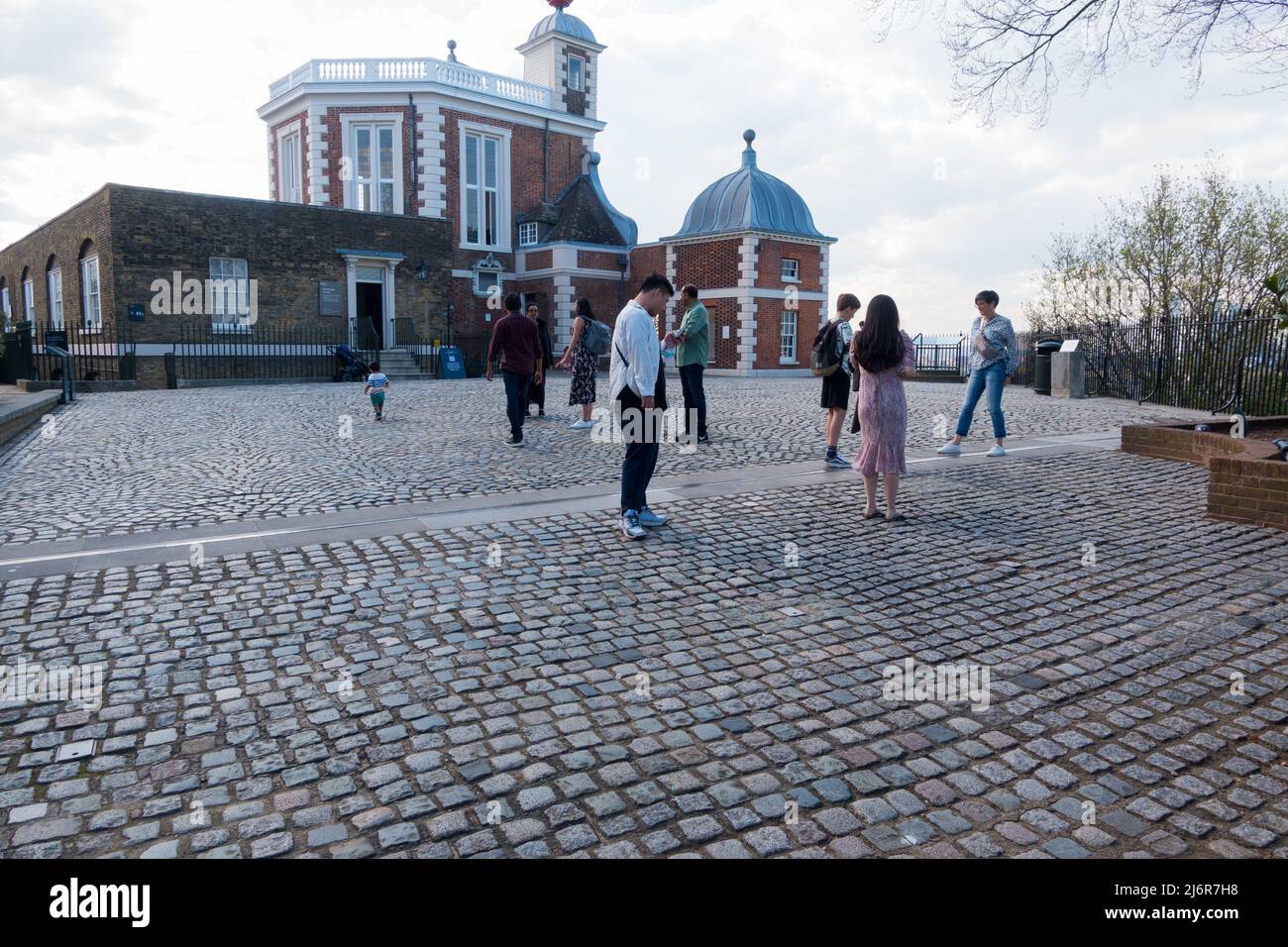 Visitors at the Royal Observatory checking the Greenwich Mean Time line on floor Stock Photo