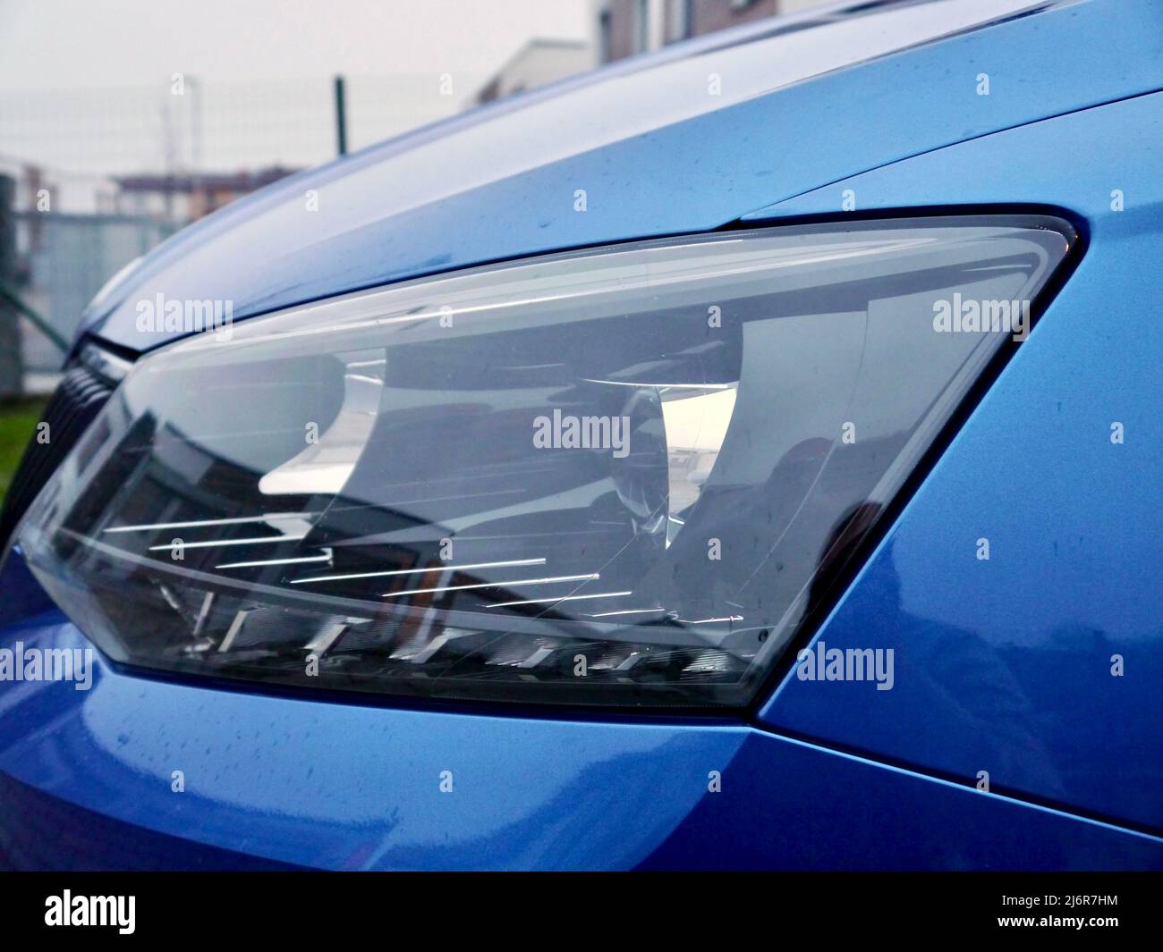 Clear headlights, modern blue car, reflections, close up Stock Photo