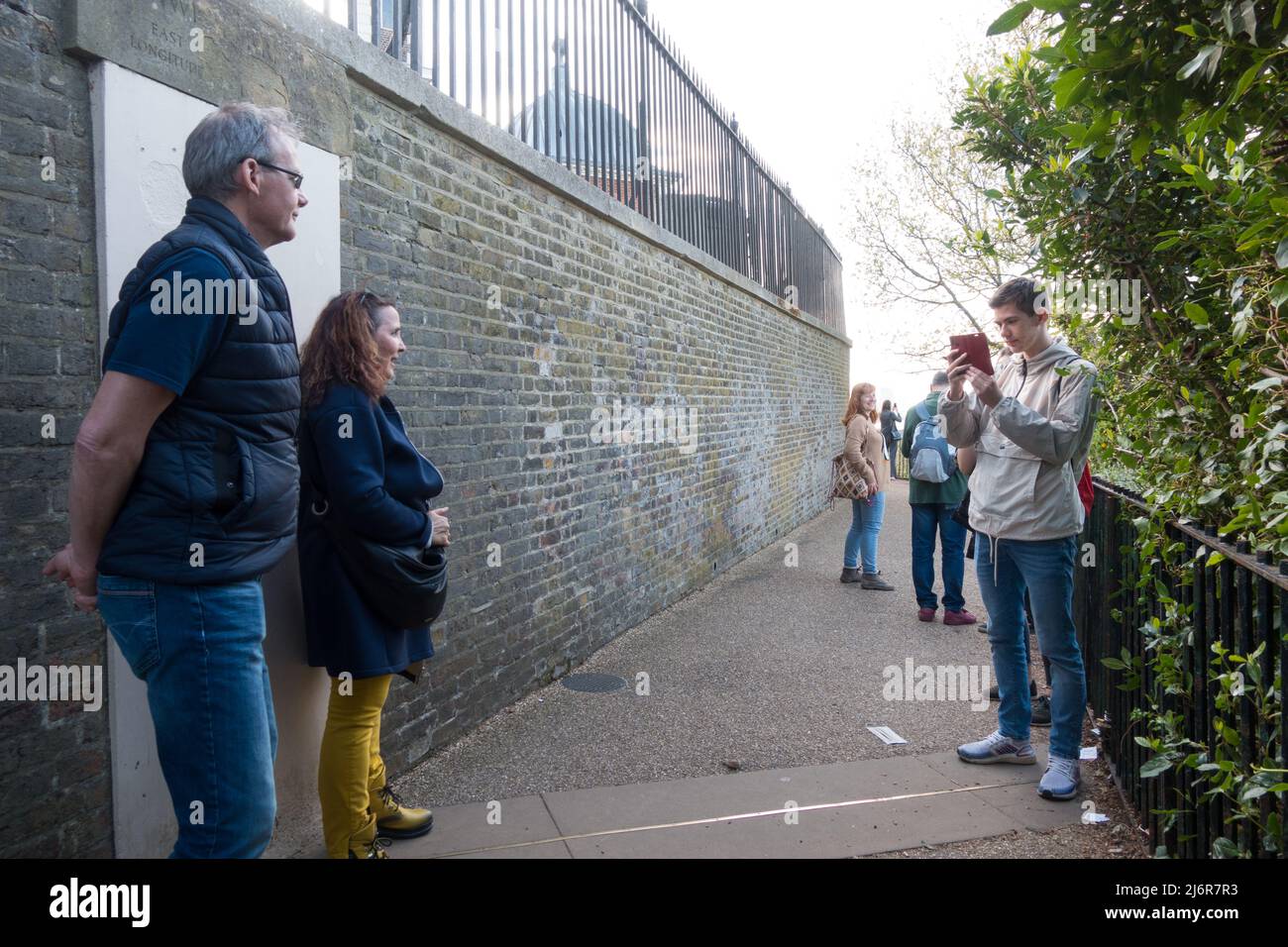 Visitors taking pictures against the Meridian line at Greenwich Stock Photo