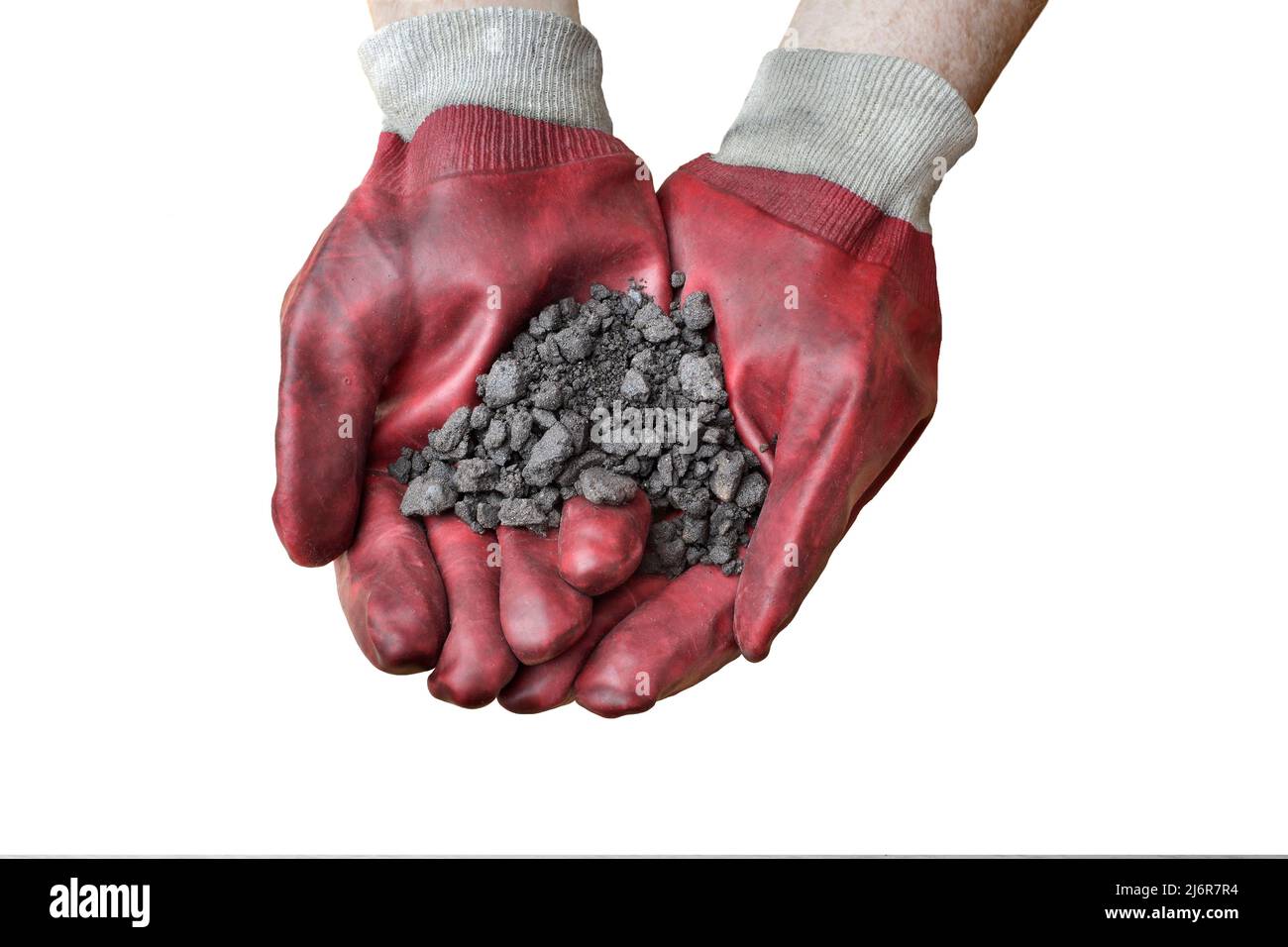 A handful of oil sand, mined from the Athabasca oil sands deposits near Fort McMurray, Alberta, Canada. Stock Photo